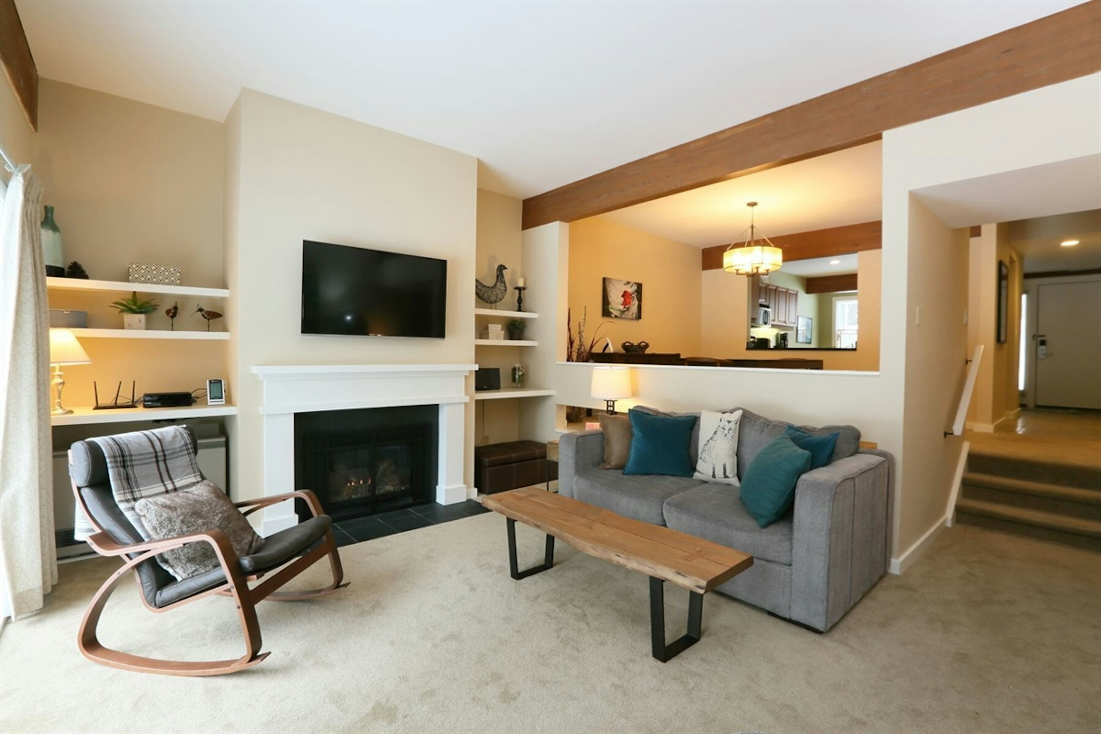 Spacious and comfortable living room with fireplace and flat screen TV