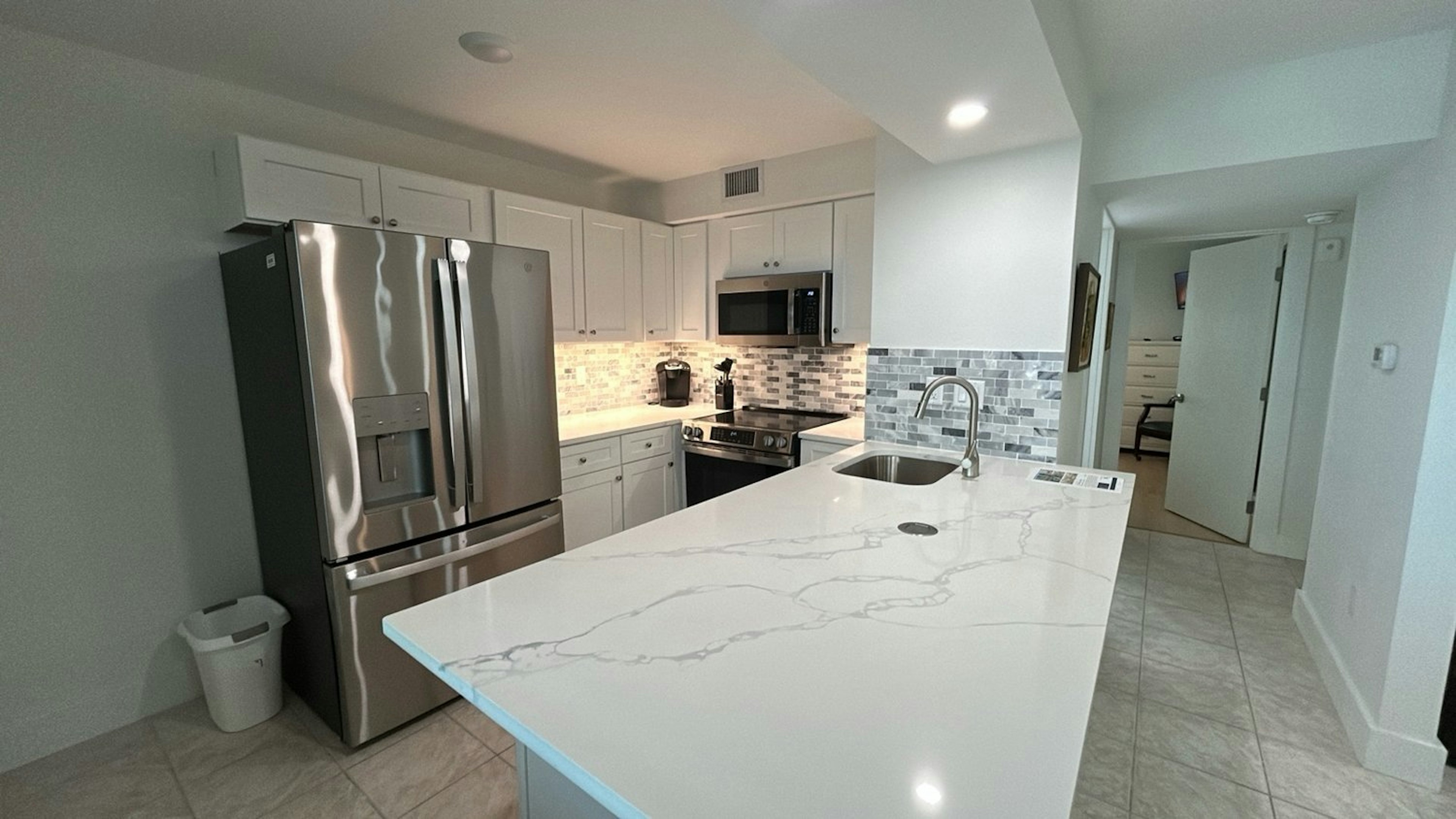 Cook your favorite meals in this stunning modern kitchen featuring granite countertops, stainless steel appliances, and ample prep space.