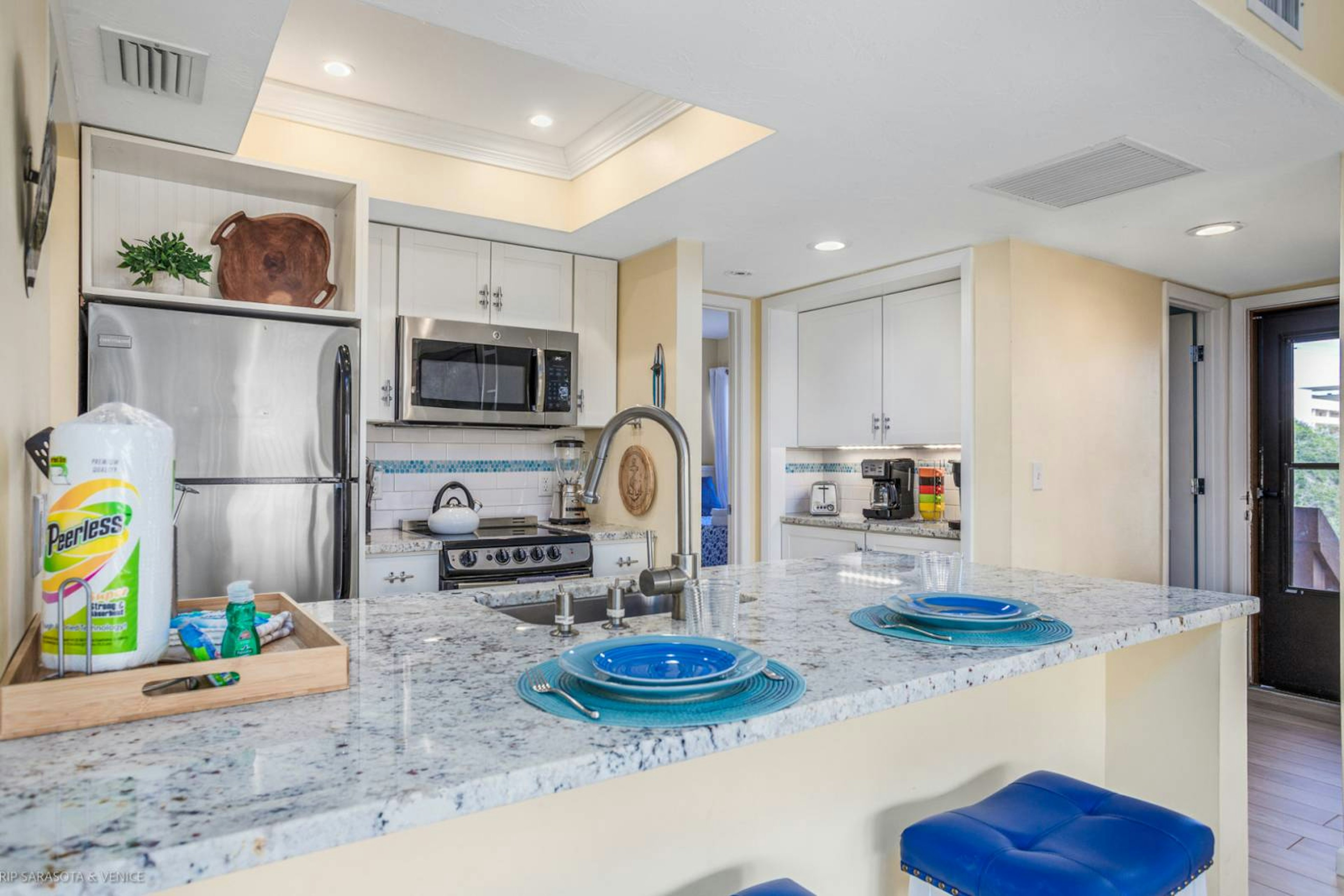 Step into your fully equipped kitchen with granite counters, stainless appliances, and thoughtful coastal touches that make cooking a joy.