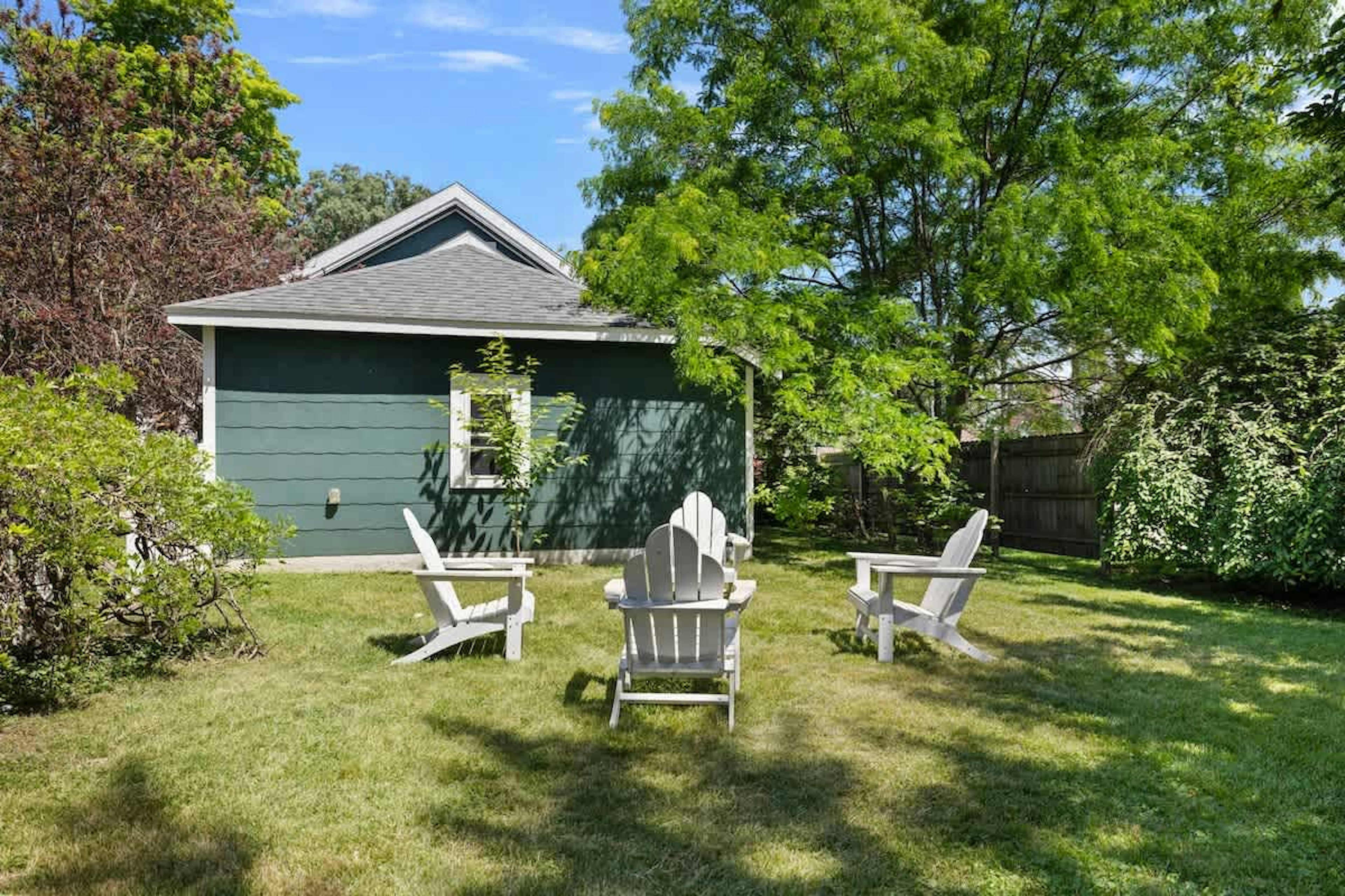 Chillin' in this backyard paradise, where the grass is always greener and the chairs are always ready for a fireside chat!