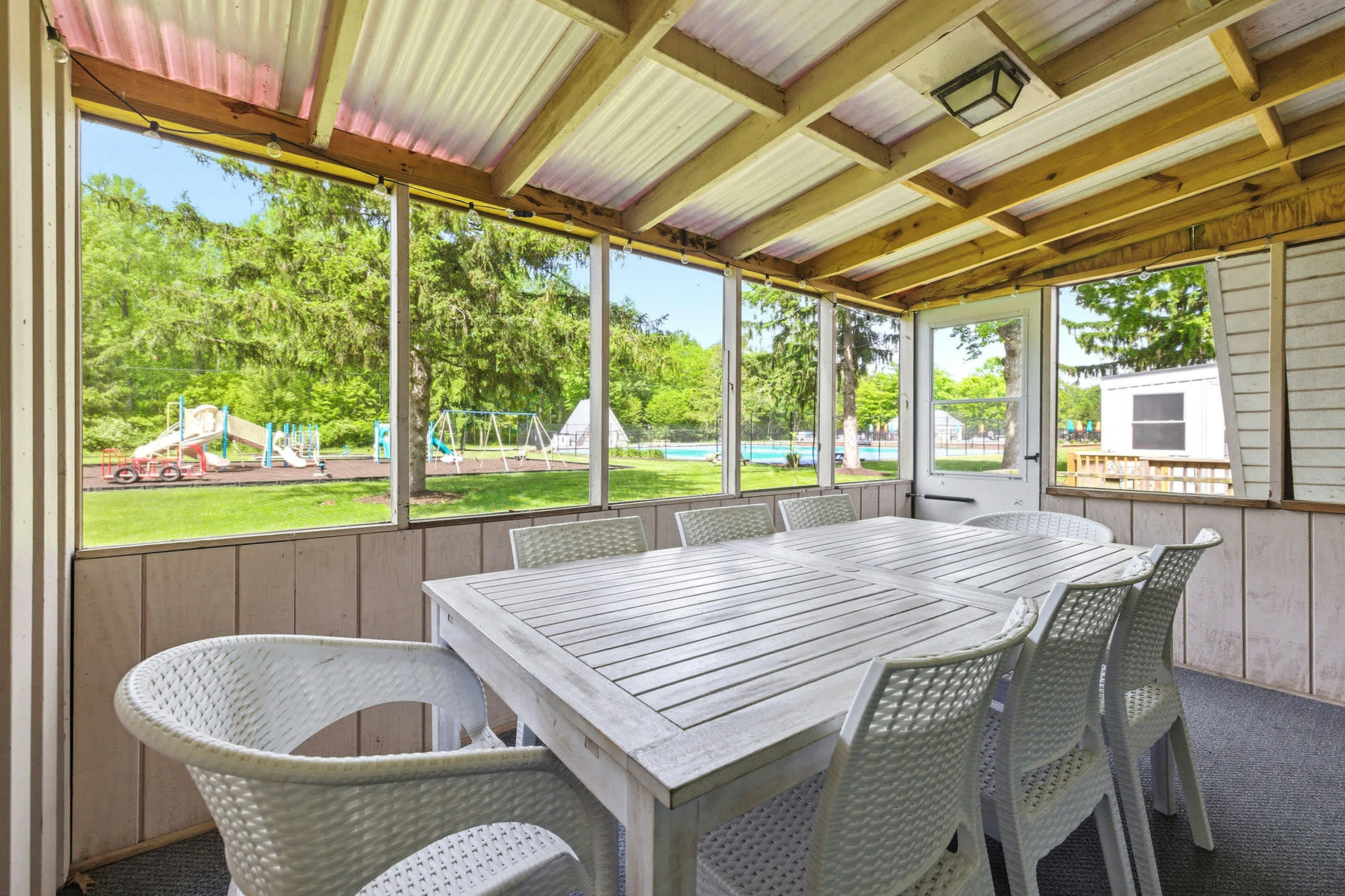 From the porch, you’re steps from pool days, playground fun, and lakeside memories.