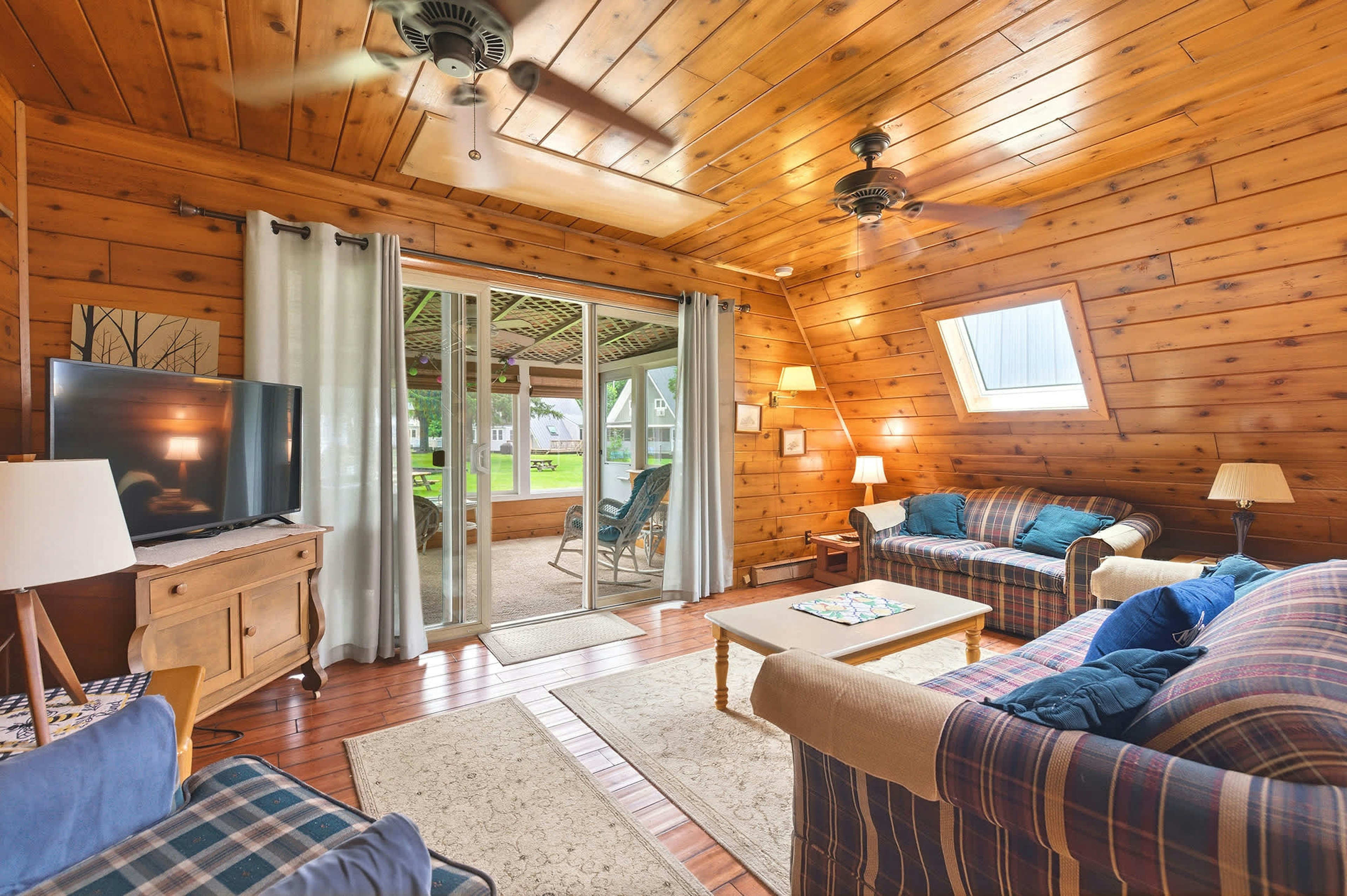 Living space extends to a screened porch overlooking resort grounds.