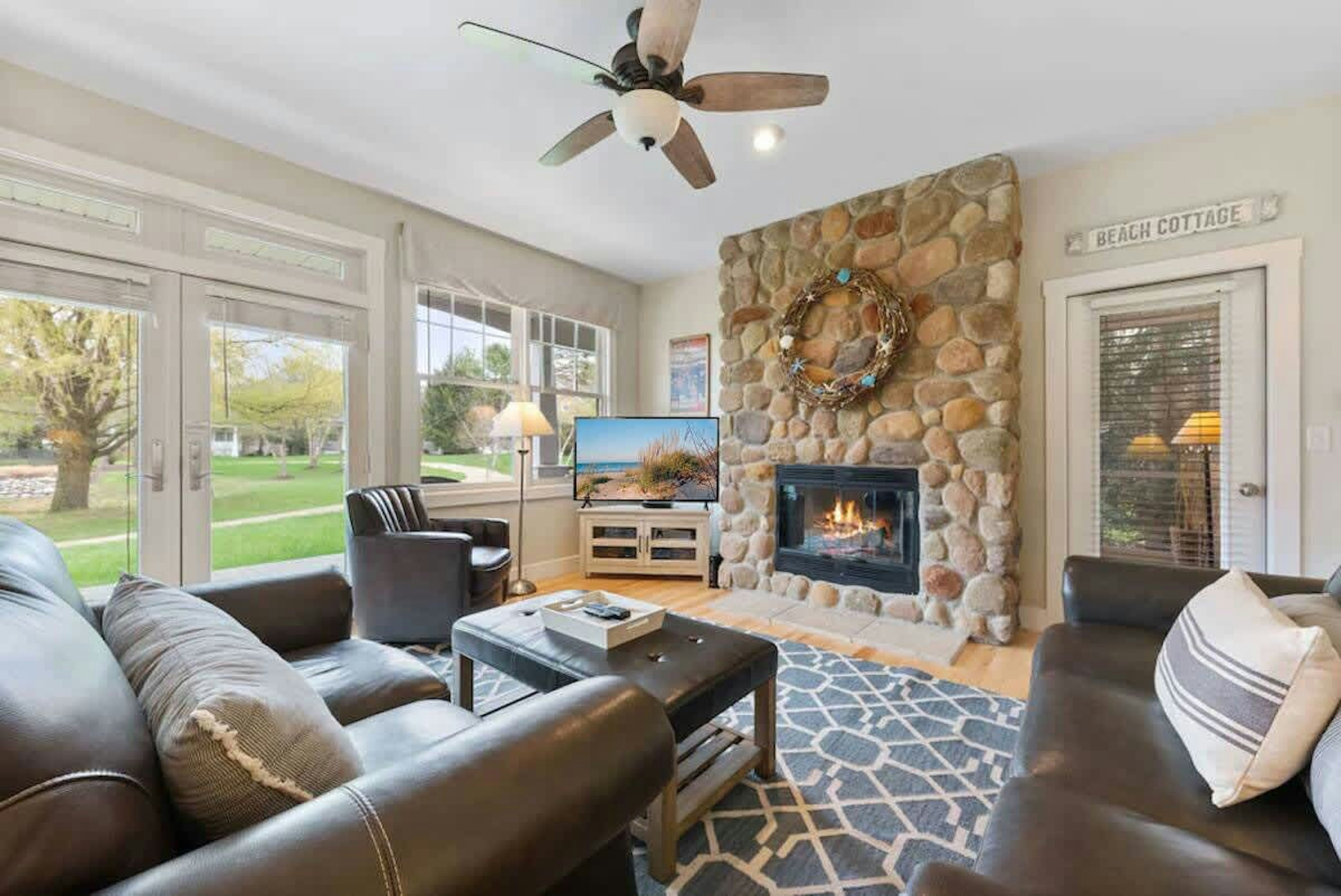 Curl up and unwind by the cozy fireplace in our warm and inviting living room.