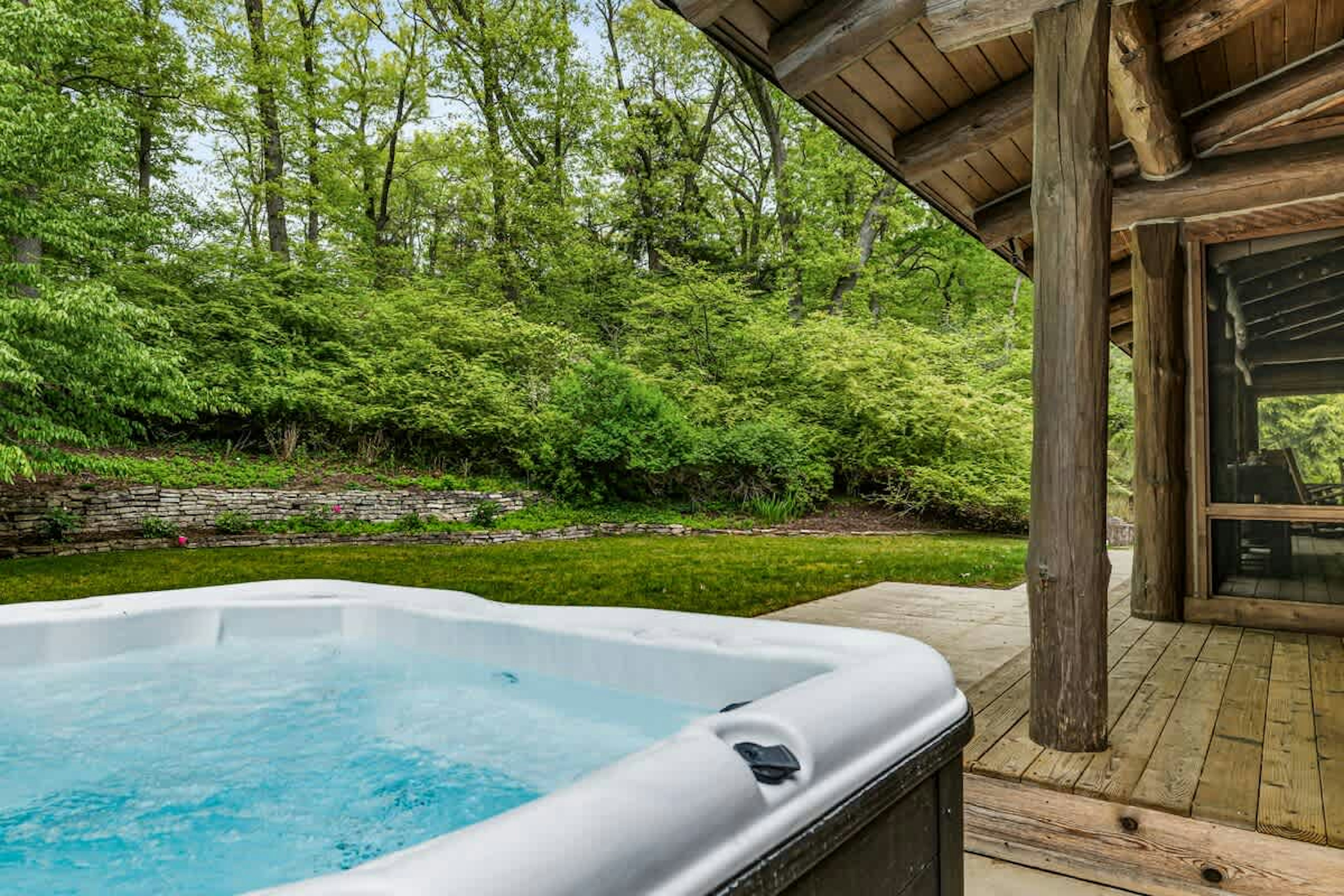 Dip into warm soak in the hot tub, surrounded by the beauty of the woods.