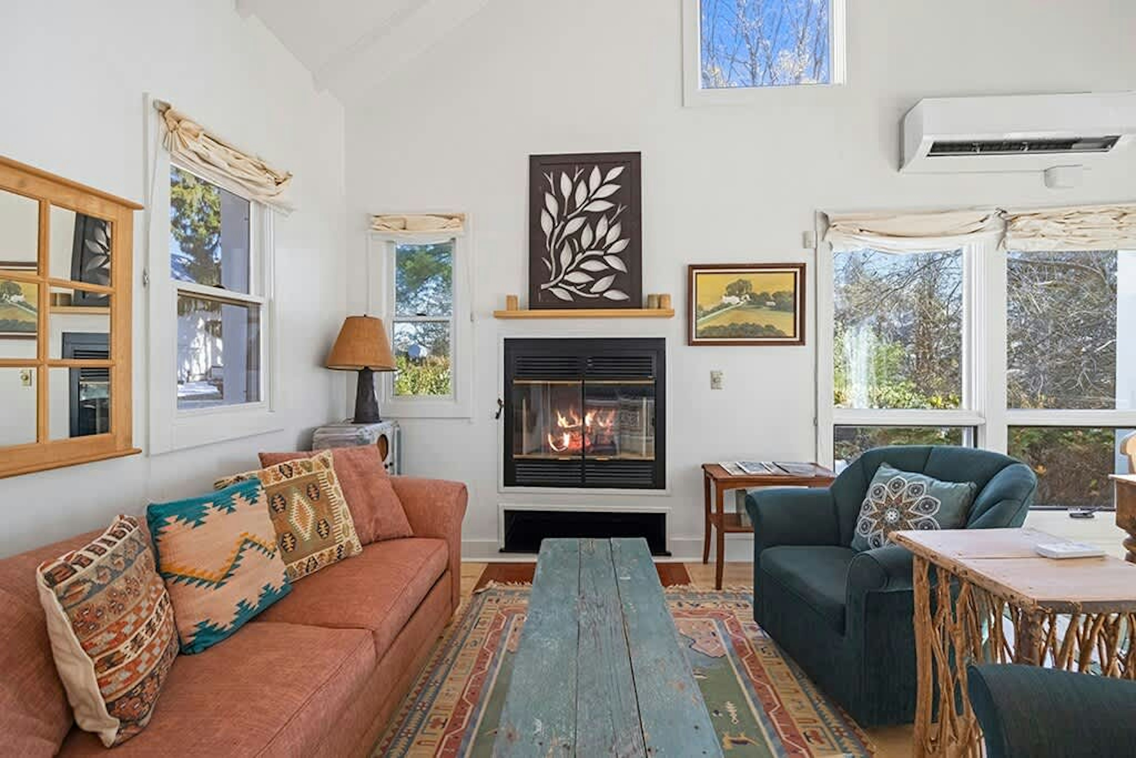 A cozy corner of The Cottage designed for unwinding by the fireplace.