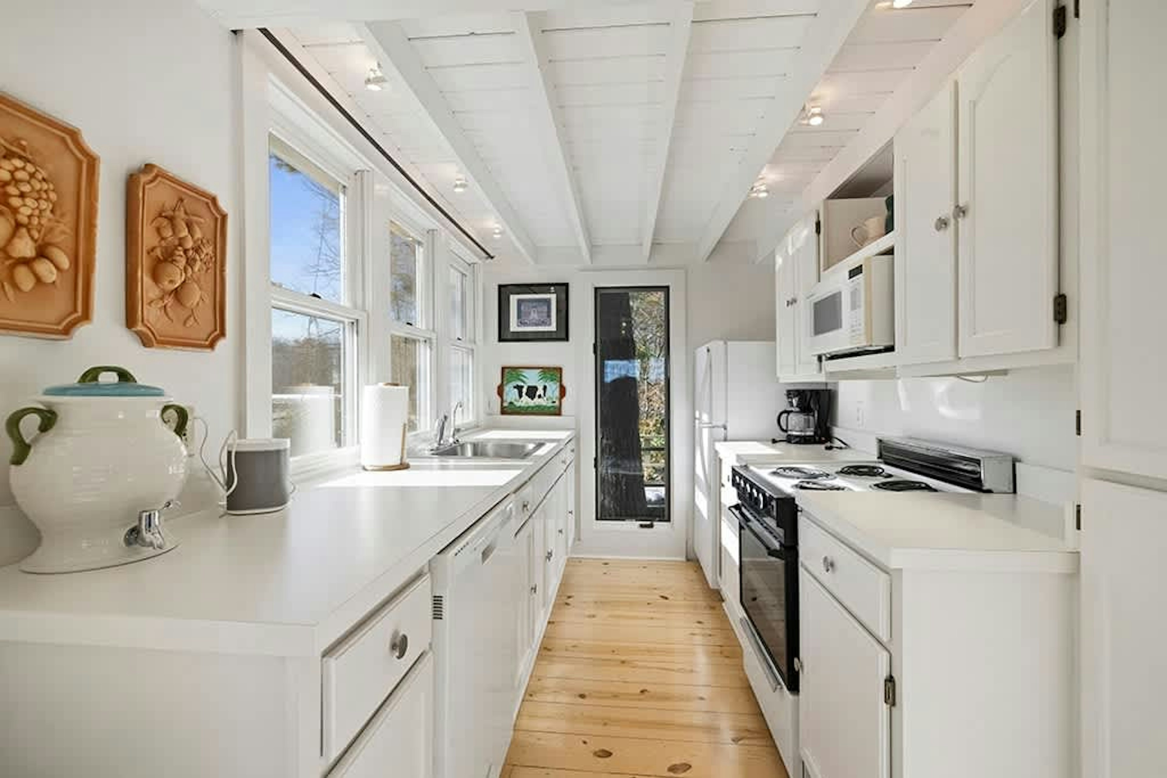 Sunlight warms The Cottage's kitchen, perfect for simple home-cooked meals.