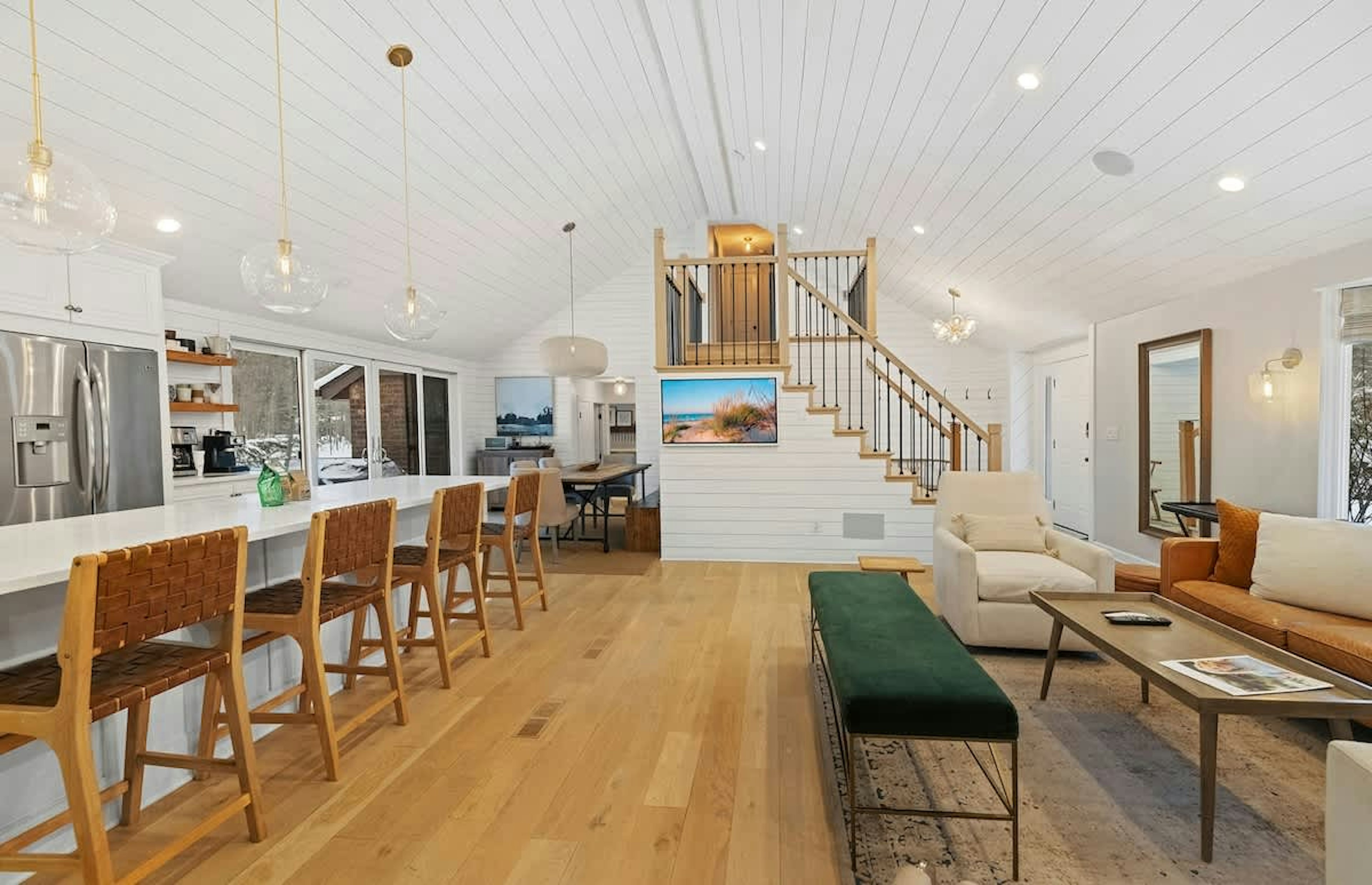 Open sightlines from kitchen to lounges make hosting seamless.