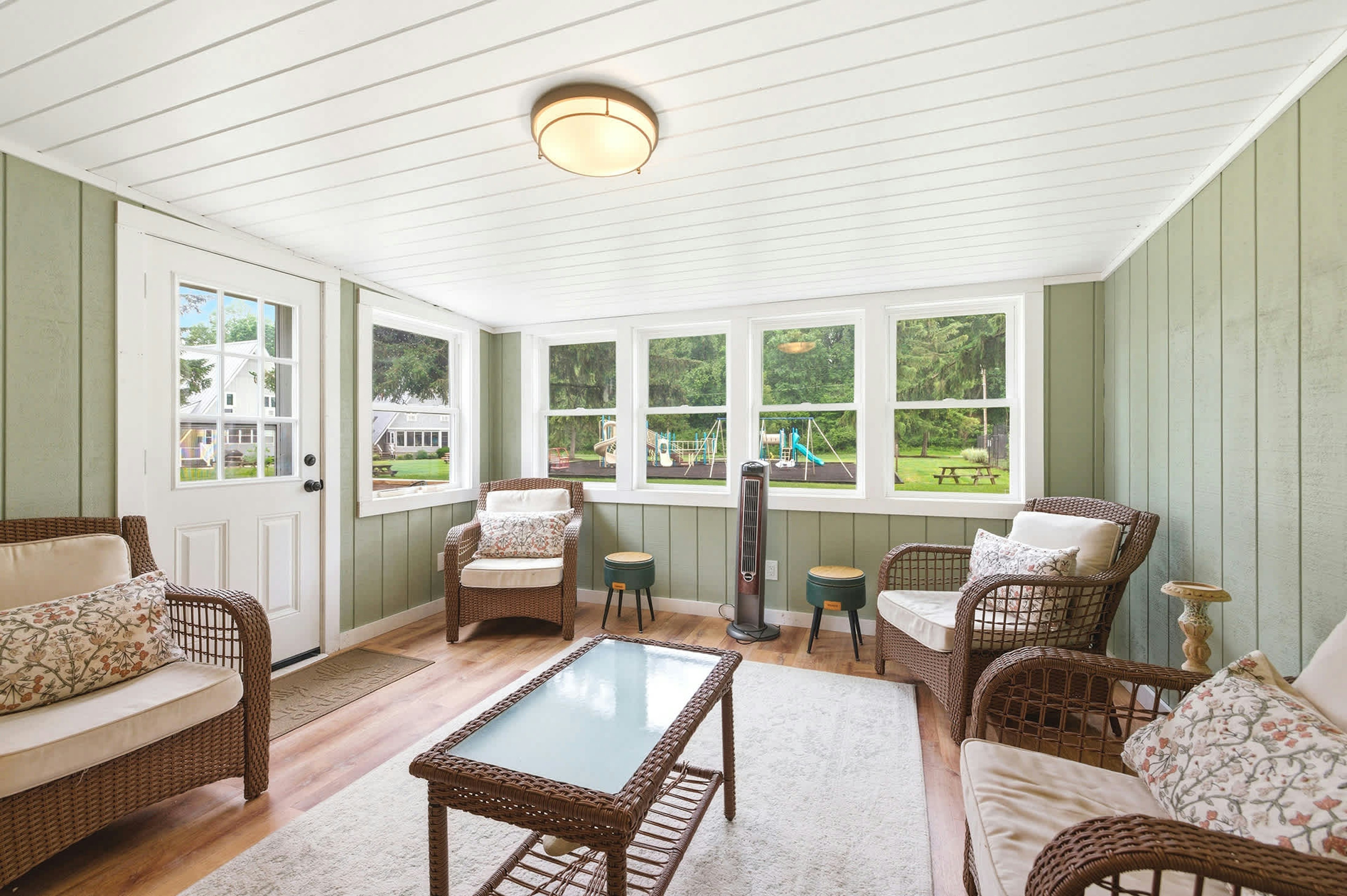Playground views from the sunroom make it easy to keep an eye on family fun.