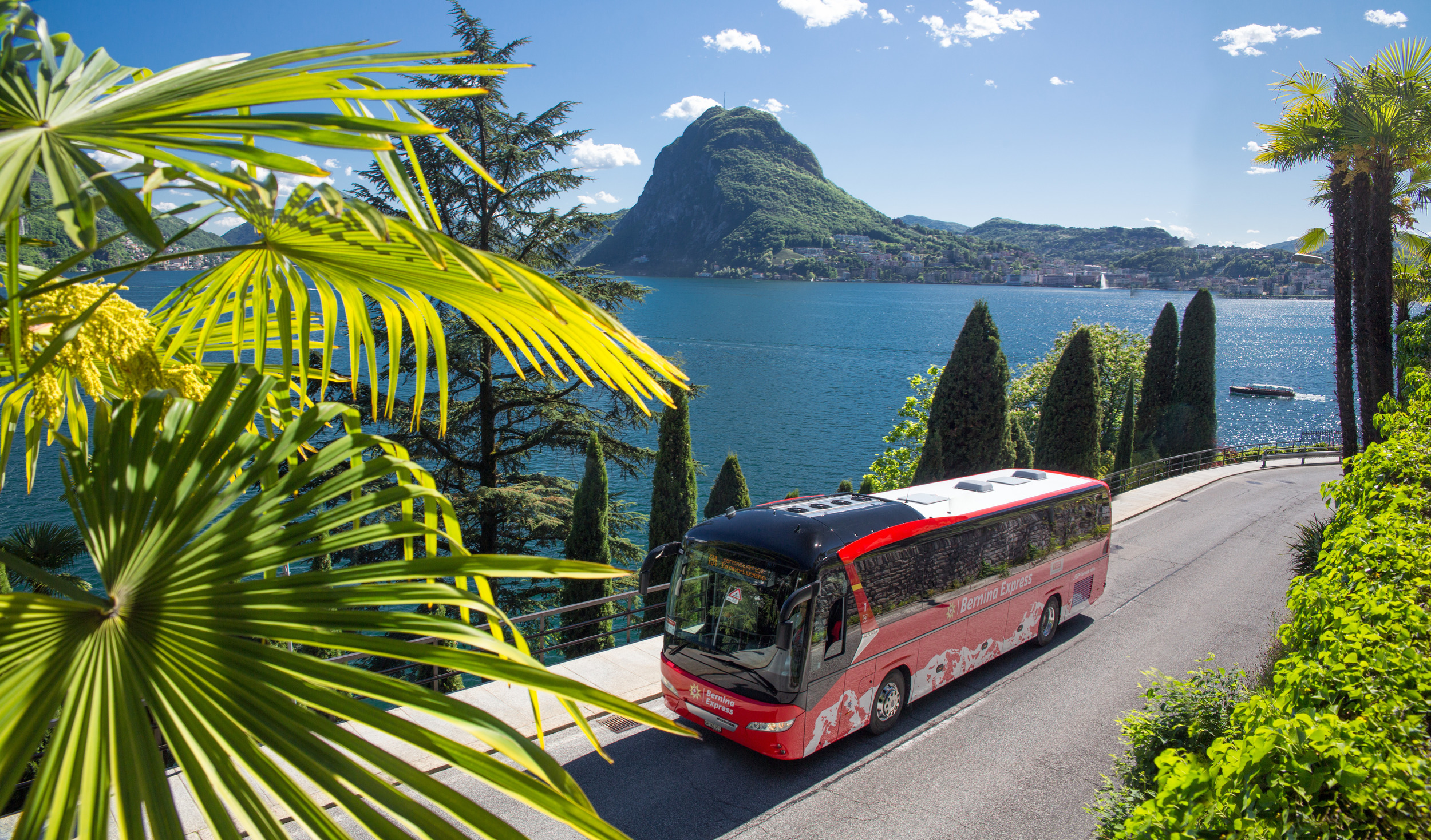 Bernina Express Bus driving in front of lake Lugano
