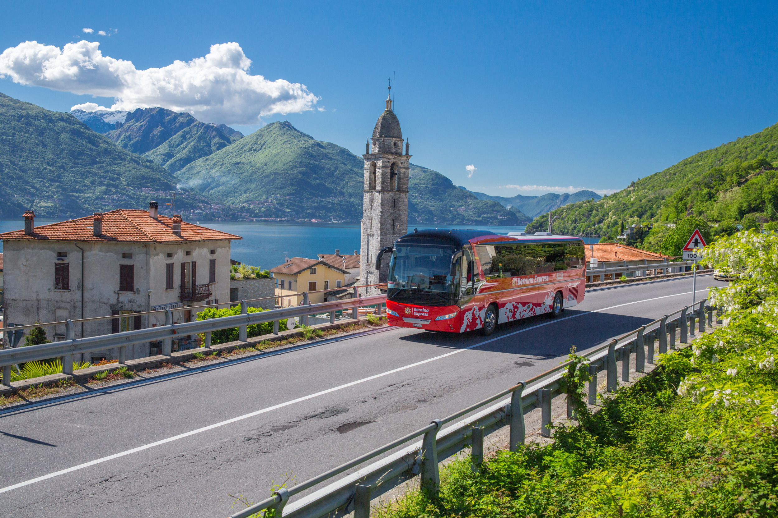 Bernina Express Bus driving in front of lake Lugano