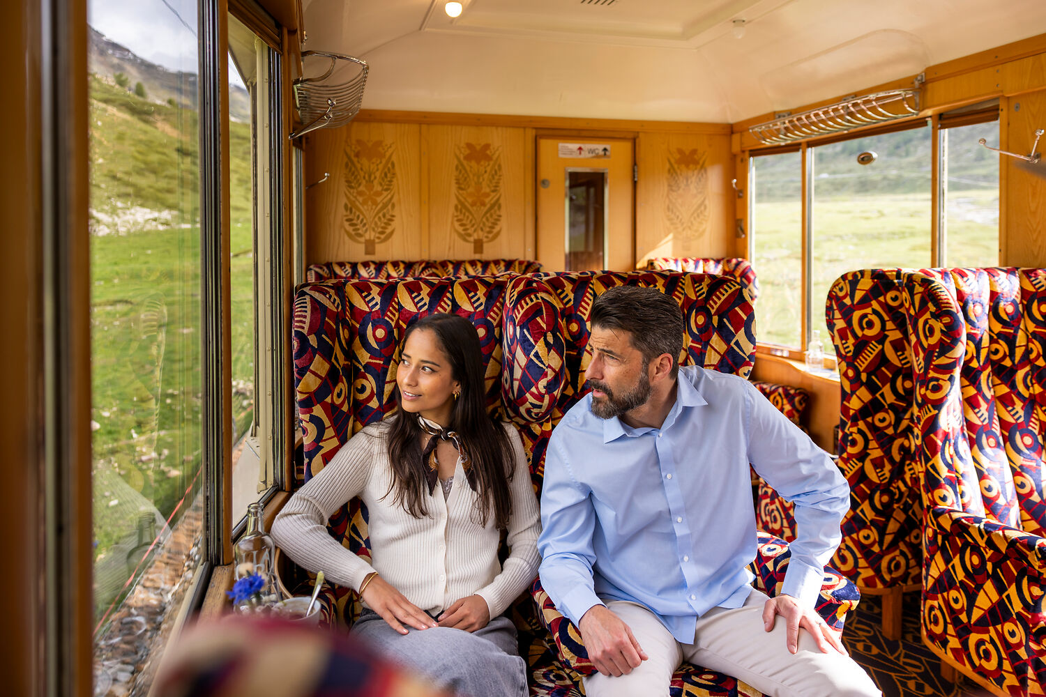 NICOLA PITARO Couple sitting in Bernina Express Pullman Class looking out of the window