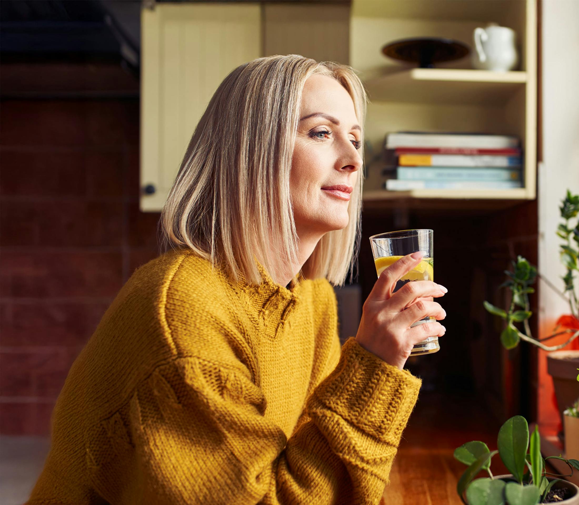 Woman drinking water and smiling
