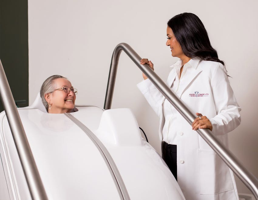 patient in sauna chamber looking at doctor