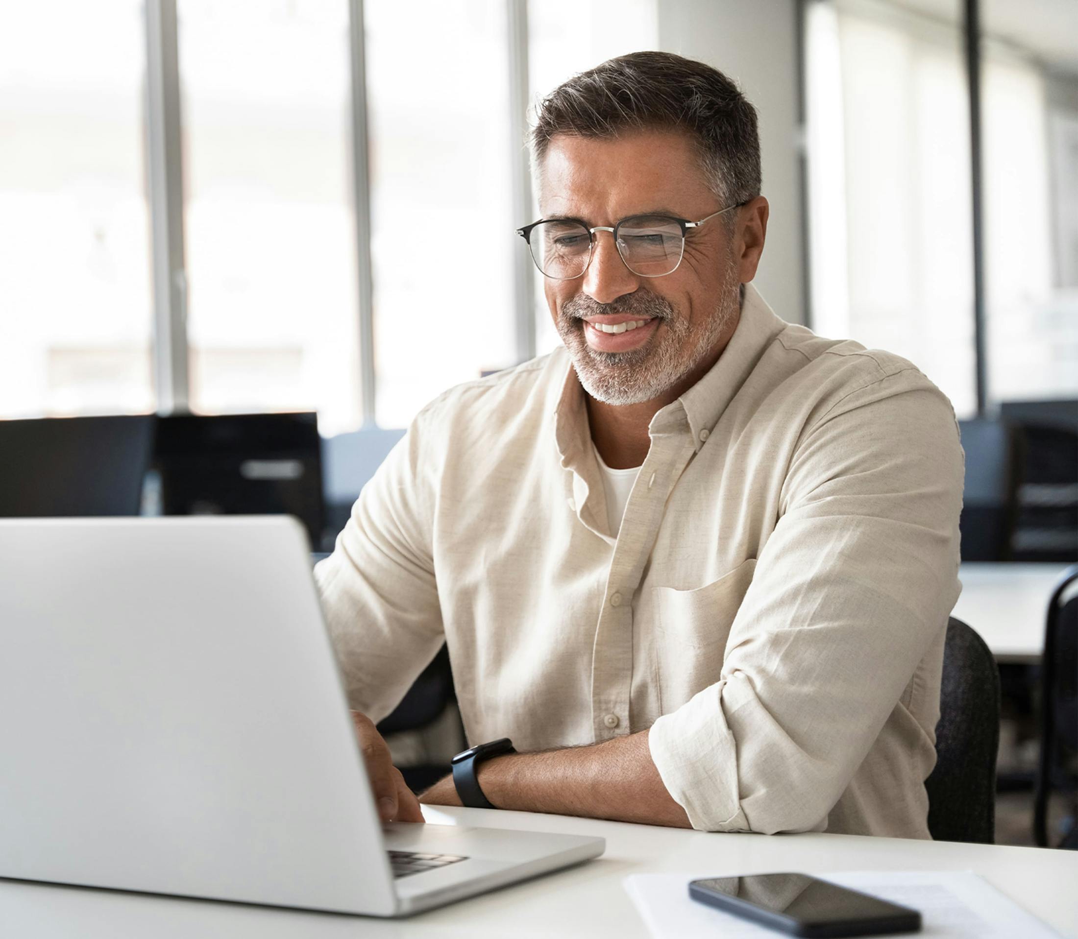 Man smiling while on a laptop