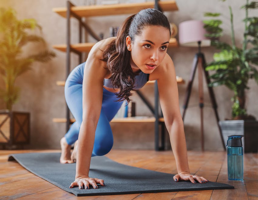 woman doing exercises on a yoga mat