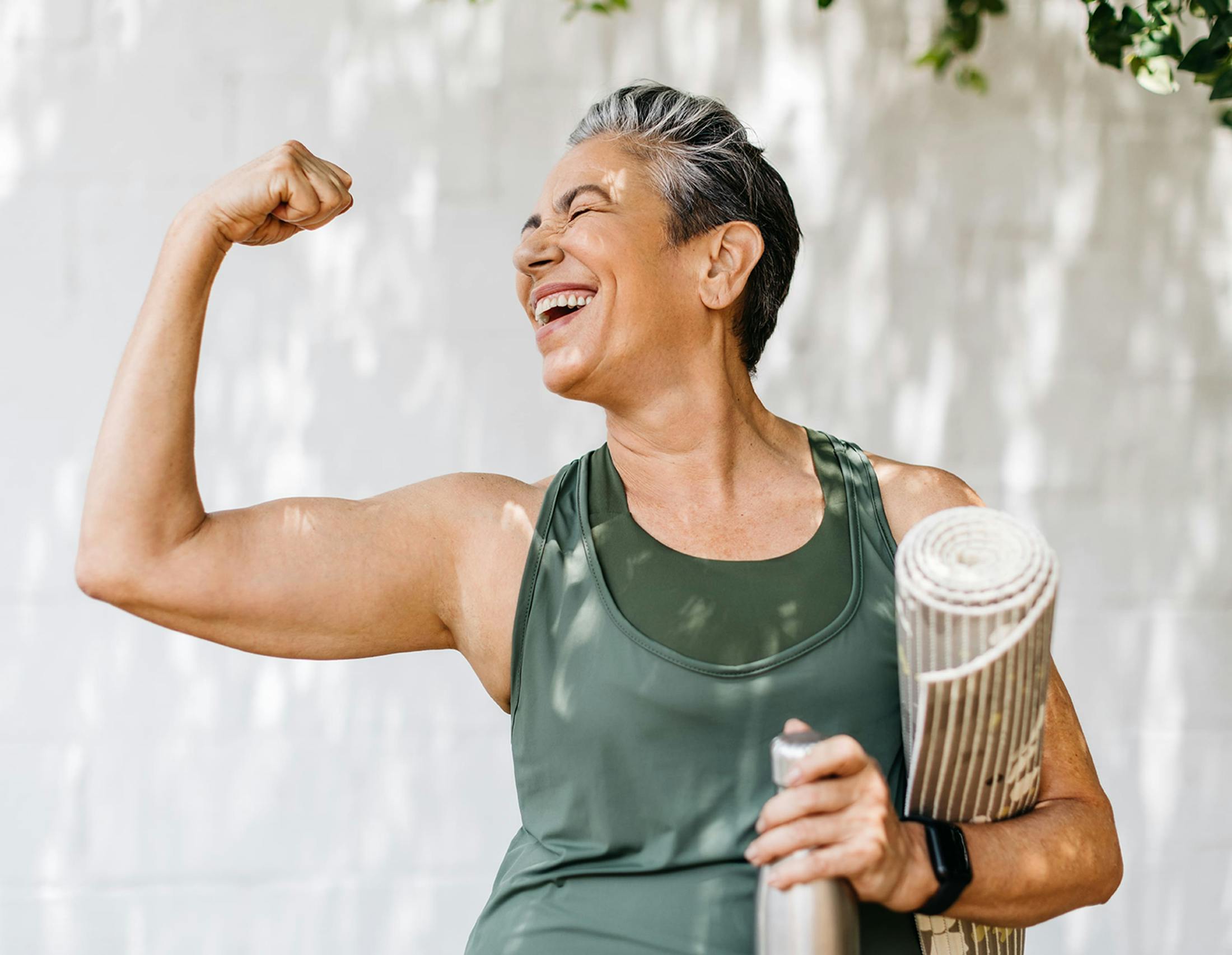 Woman flexing muscle and smiling