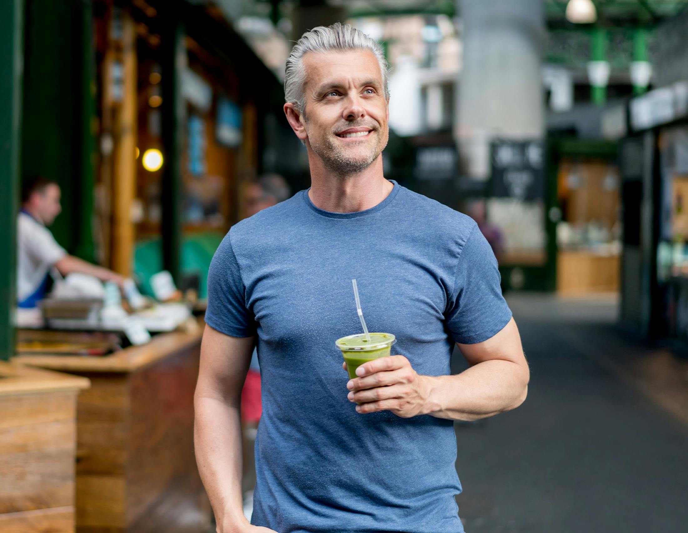 Man holding drink smiling