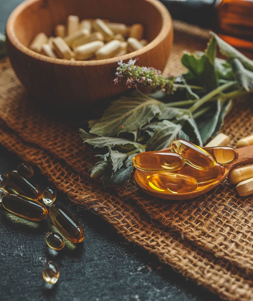 Suppliments in a bowl and herbs
