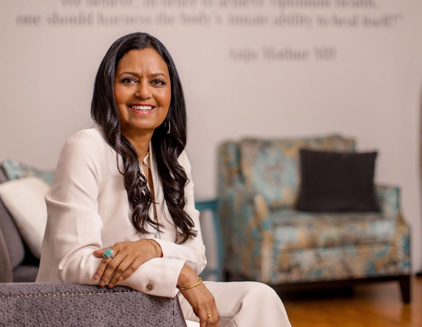 Dr. Mathur sitting and smiling