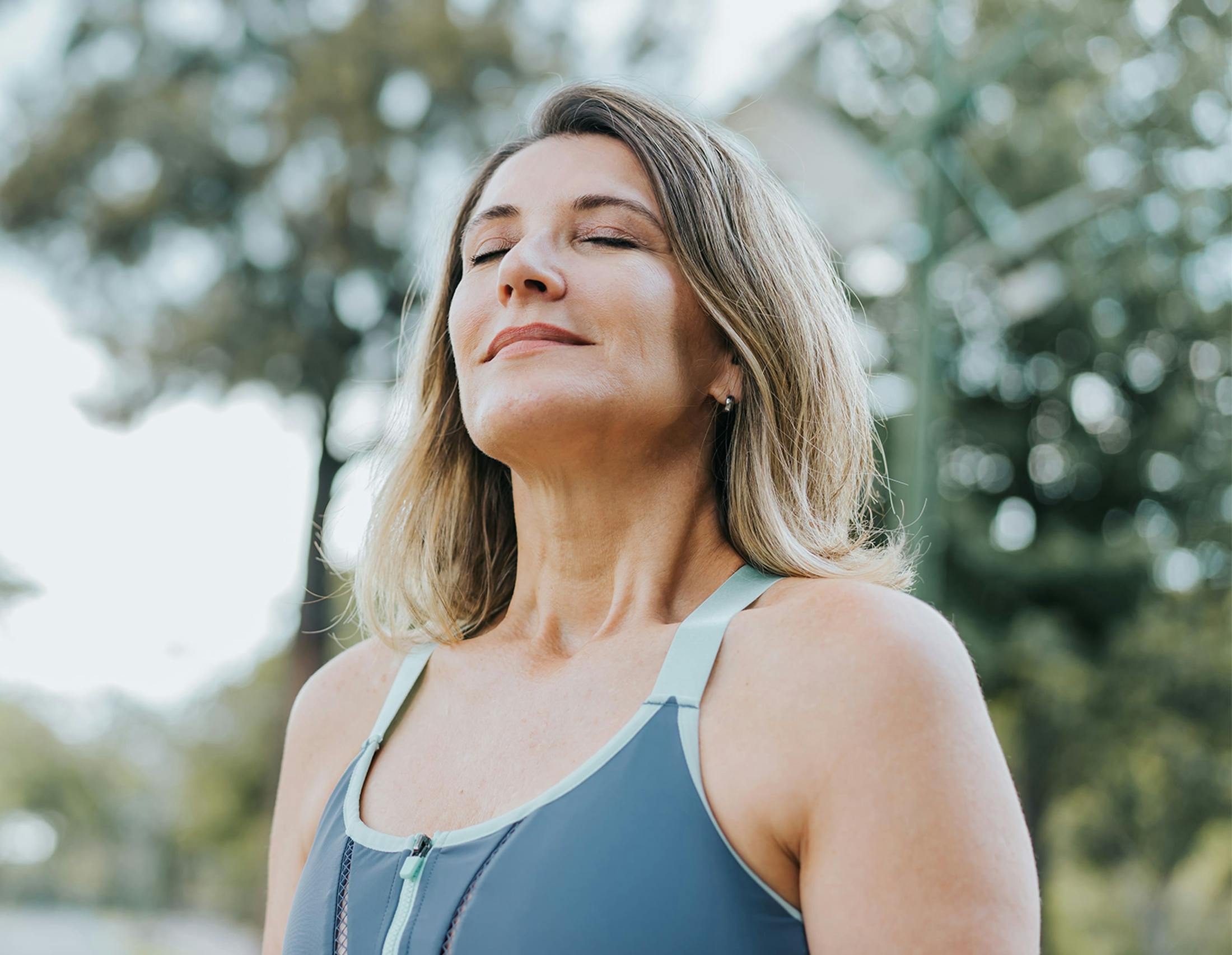 Woman taking a deep breath outside