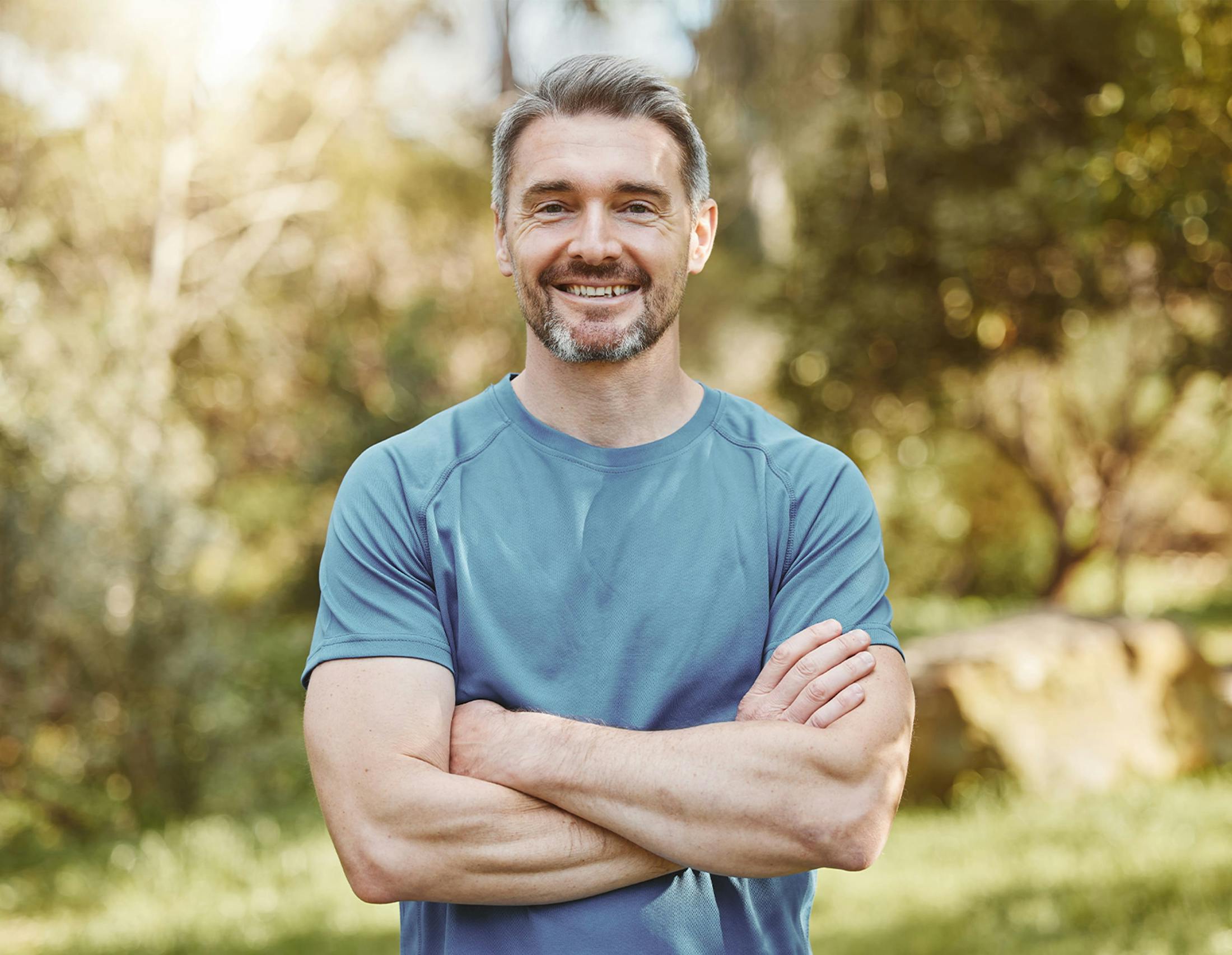 Man with arms crossed smiling