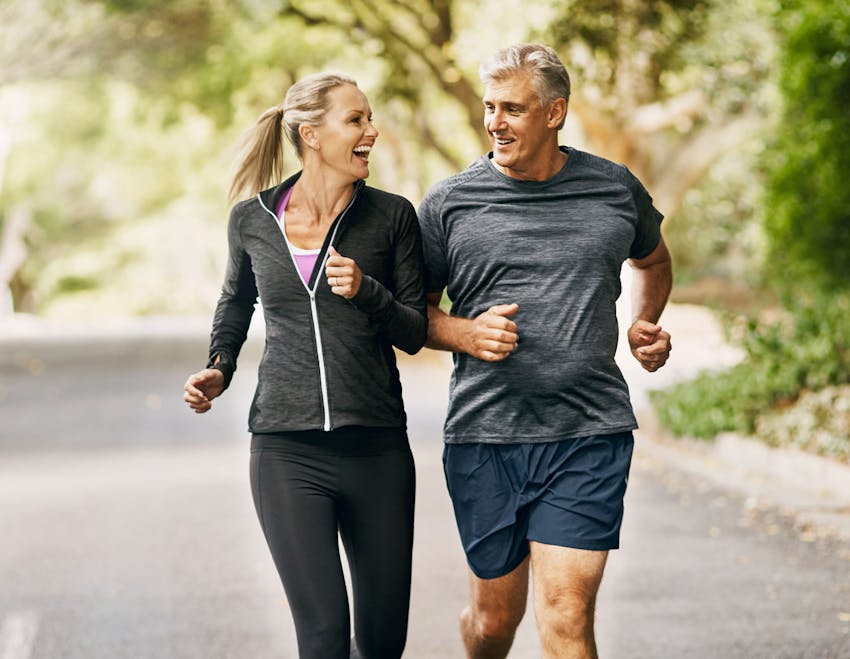 Man and woman running and smiling