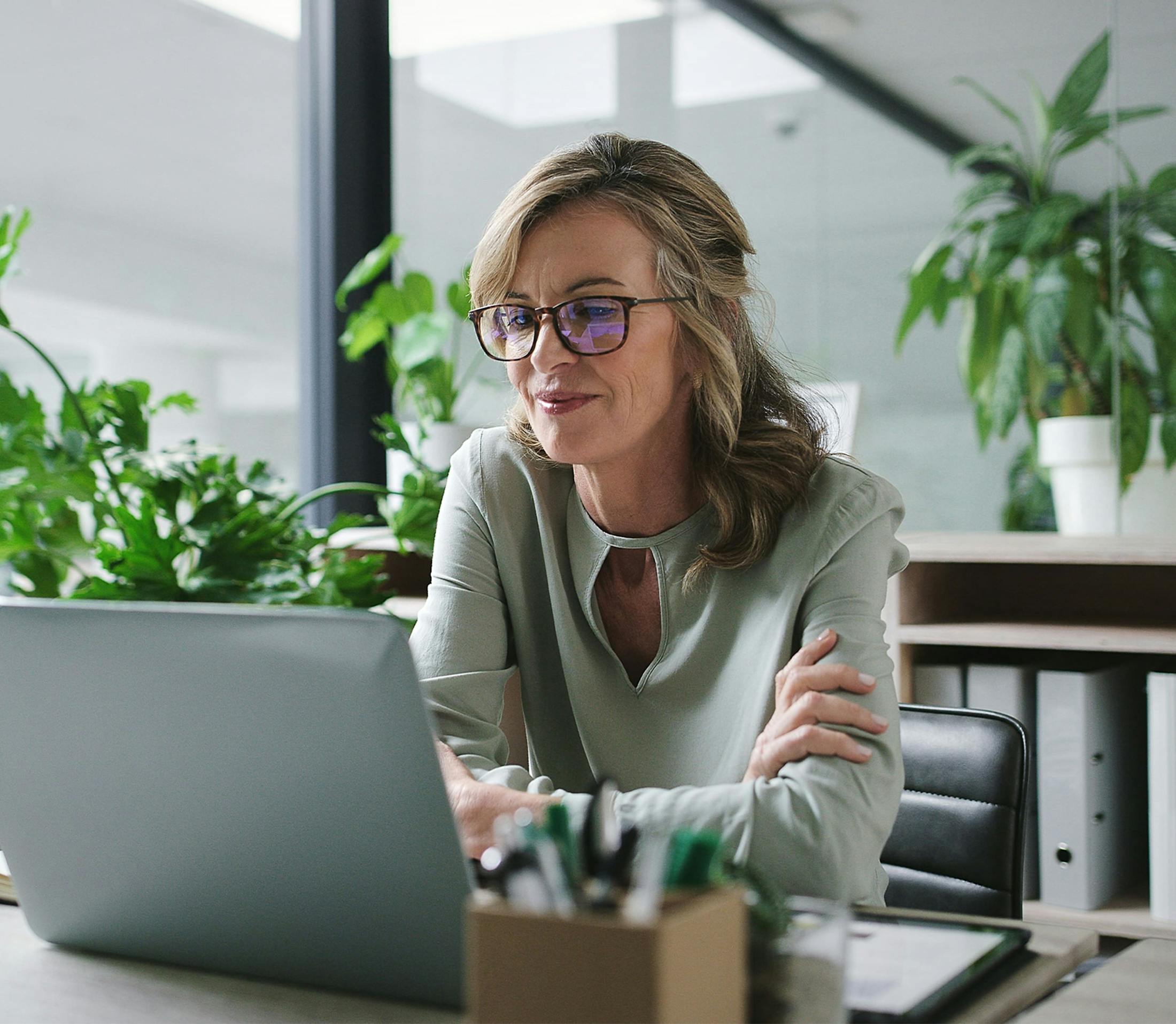 Woman looking at laptop and smiling