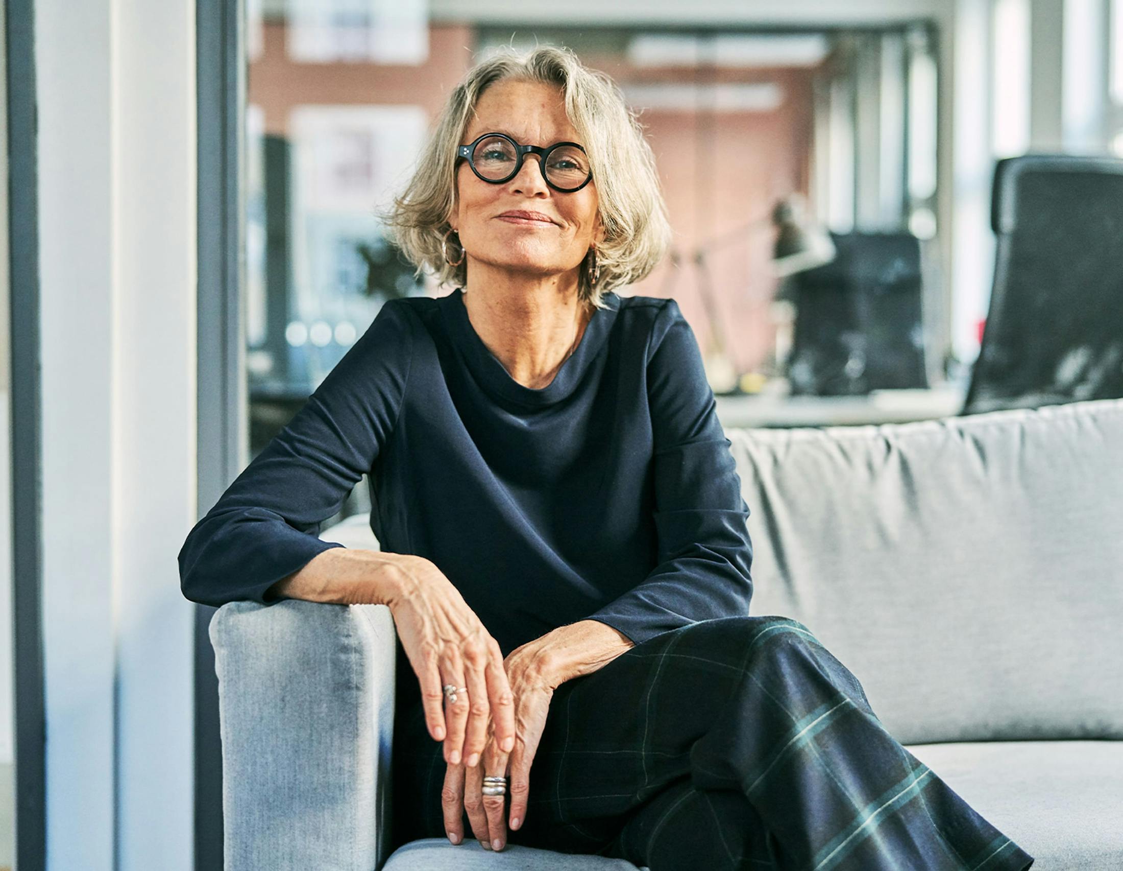 Woman sitting on a couch smiling