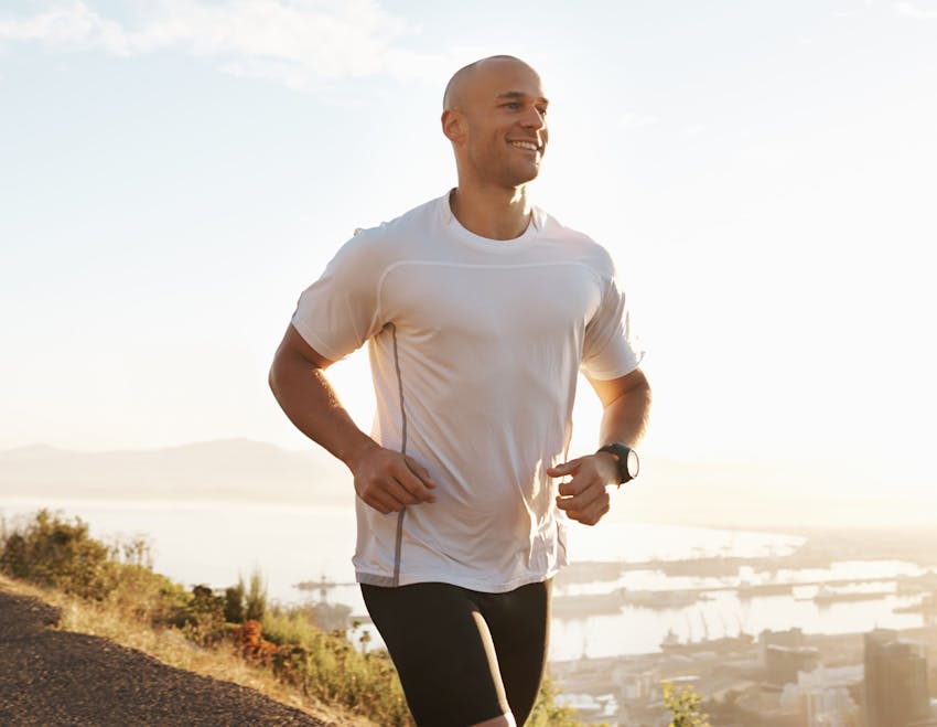 Man running outside smiling