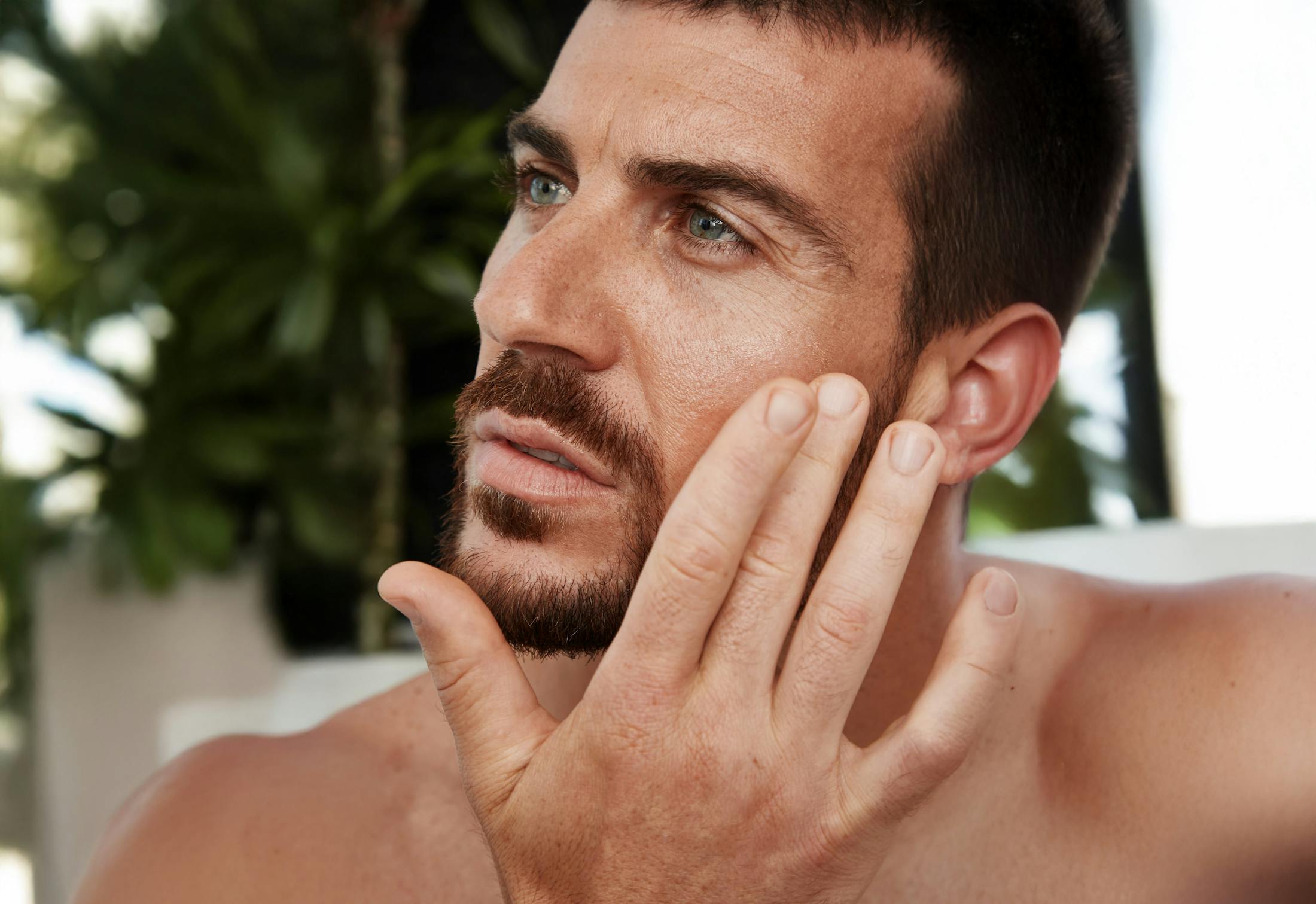 man touching his face