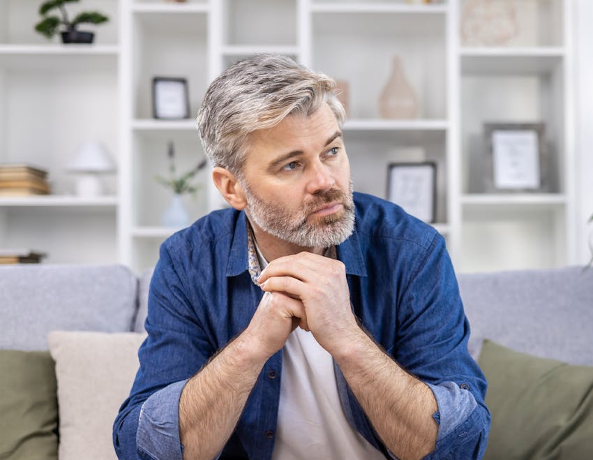 a gloved hand pulling a vile of blood out of a centrifuge