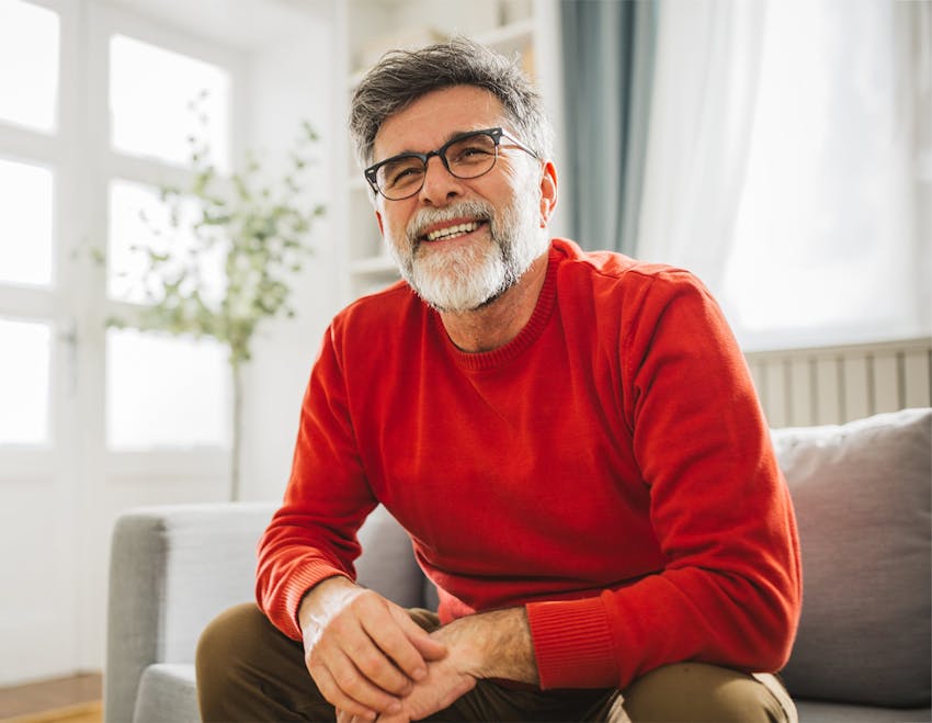 man on couch smiling