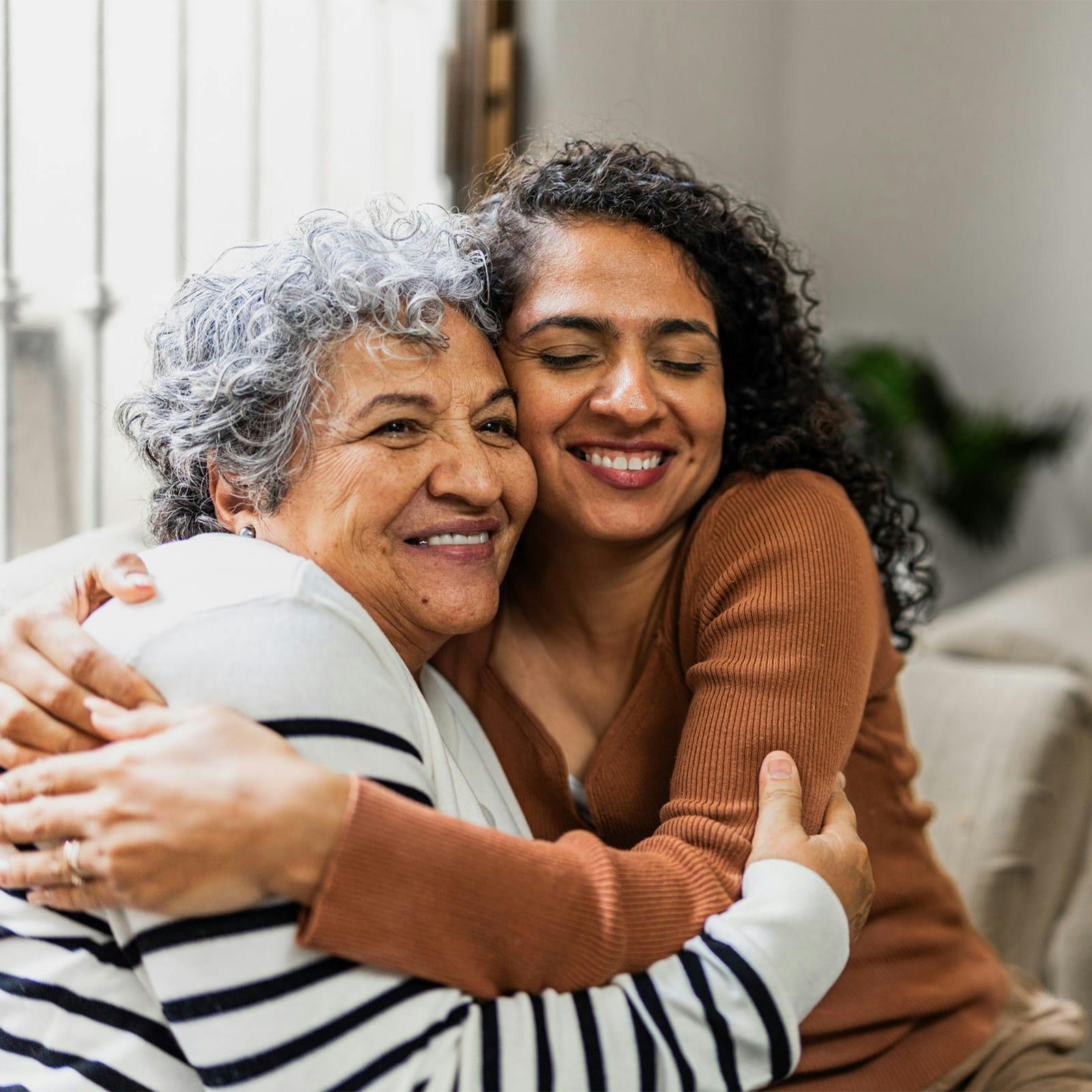 older woman and younger woman embracing