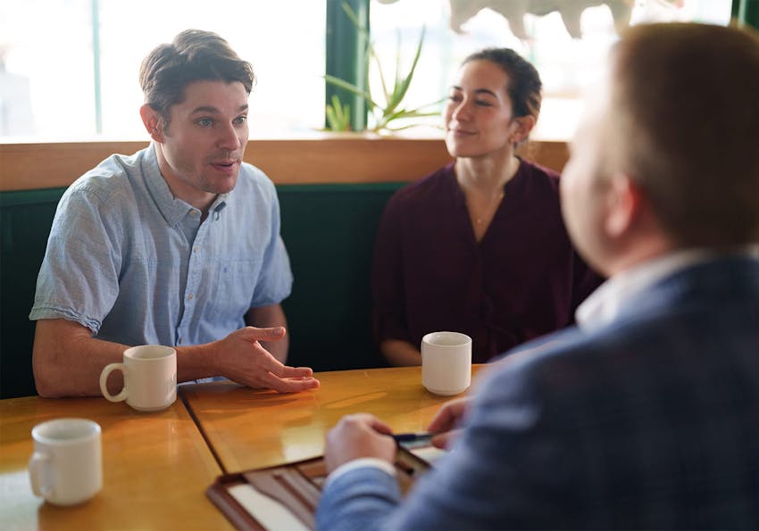 attorney talking to a client over coffee