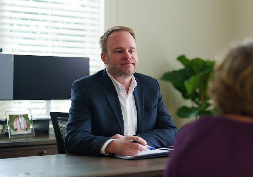 attorney talking to a client at a desk
