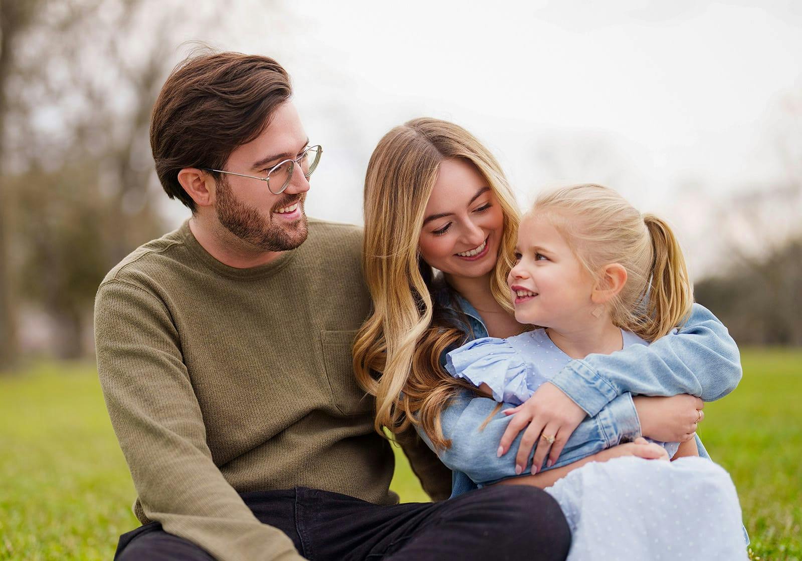 man and woman sitting with a child