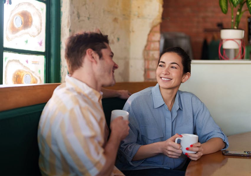man and woman talking over coffee