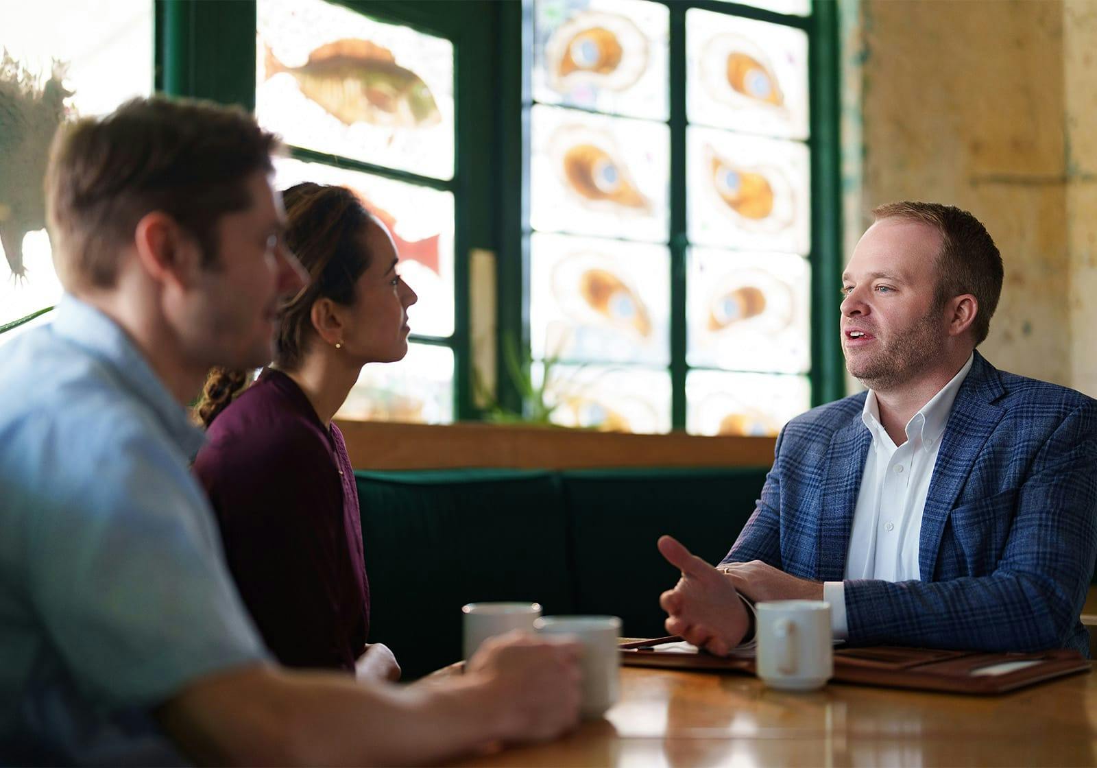 attorney talking to clients over coffee