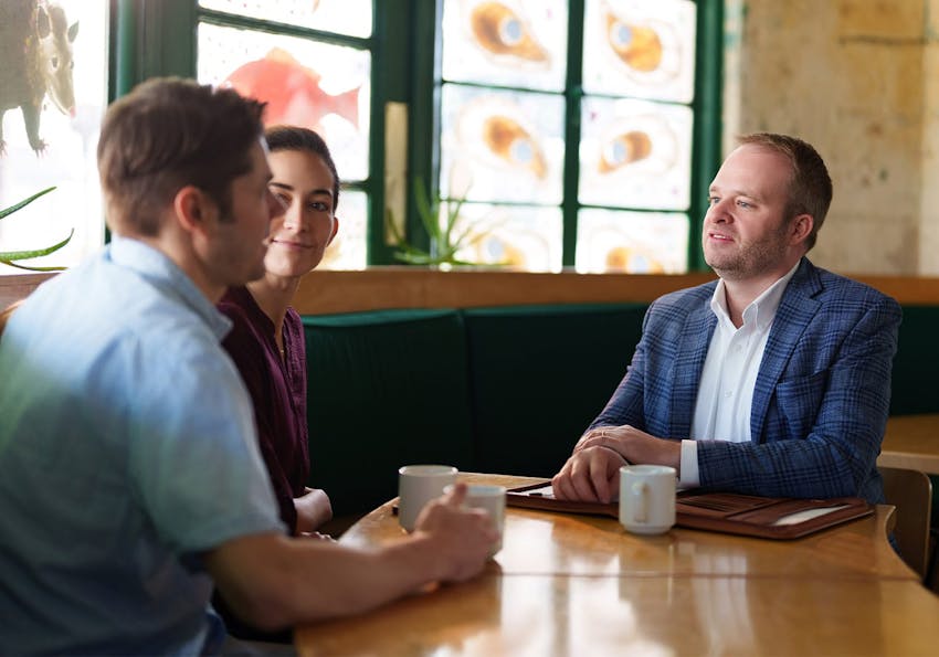 attorney talking to clients over coffee