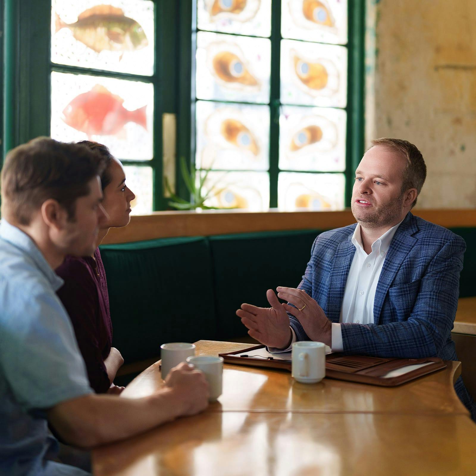 attorney talking to clients over coffee