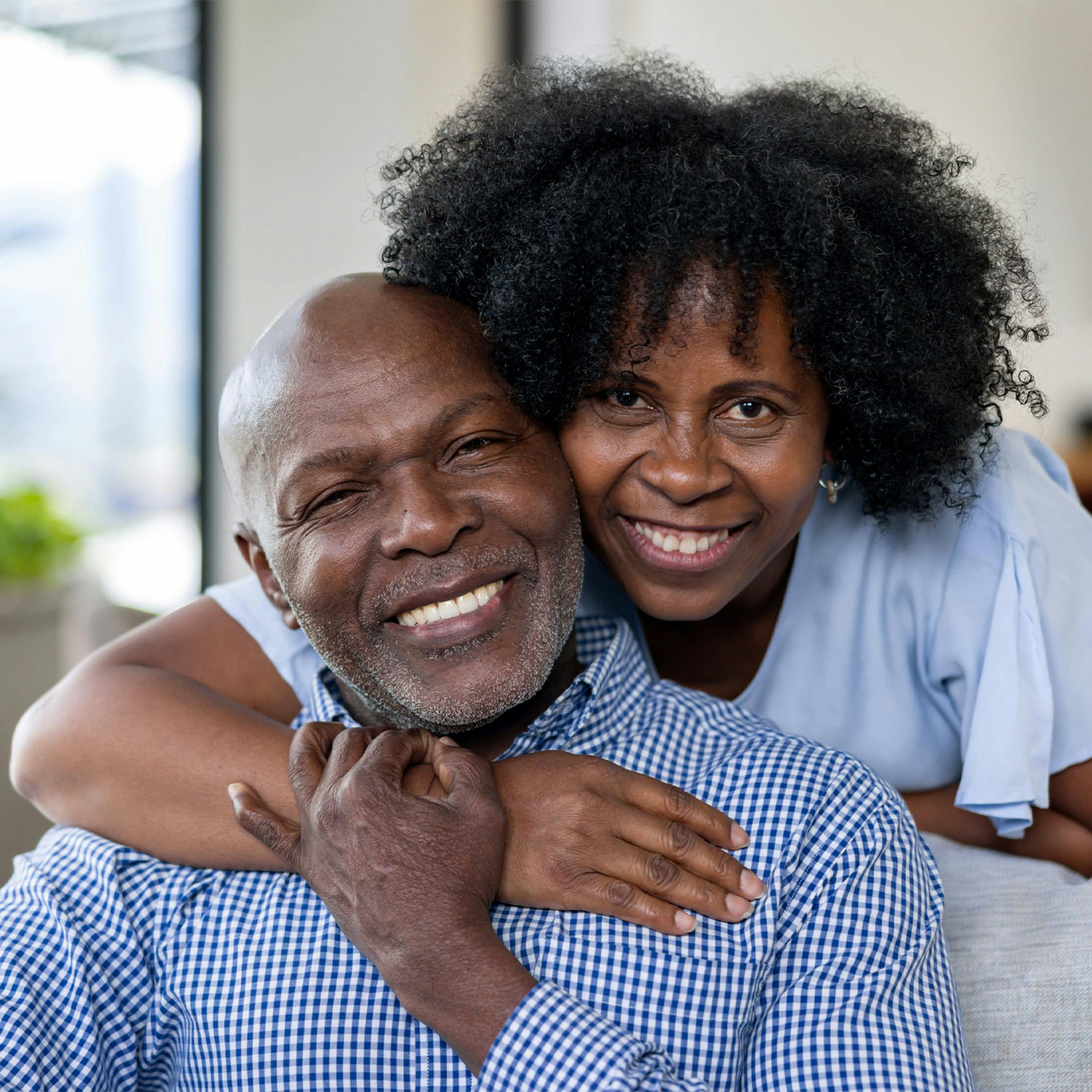 older woman hugging an older man from behind