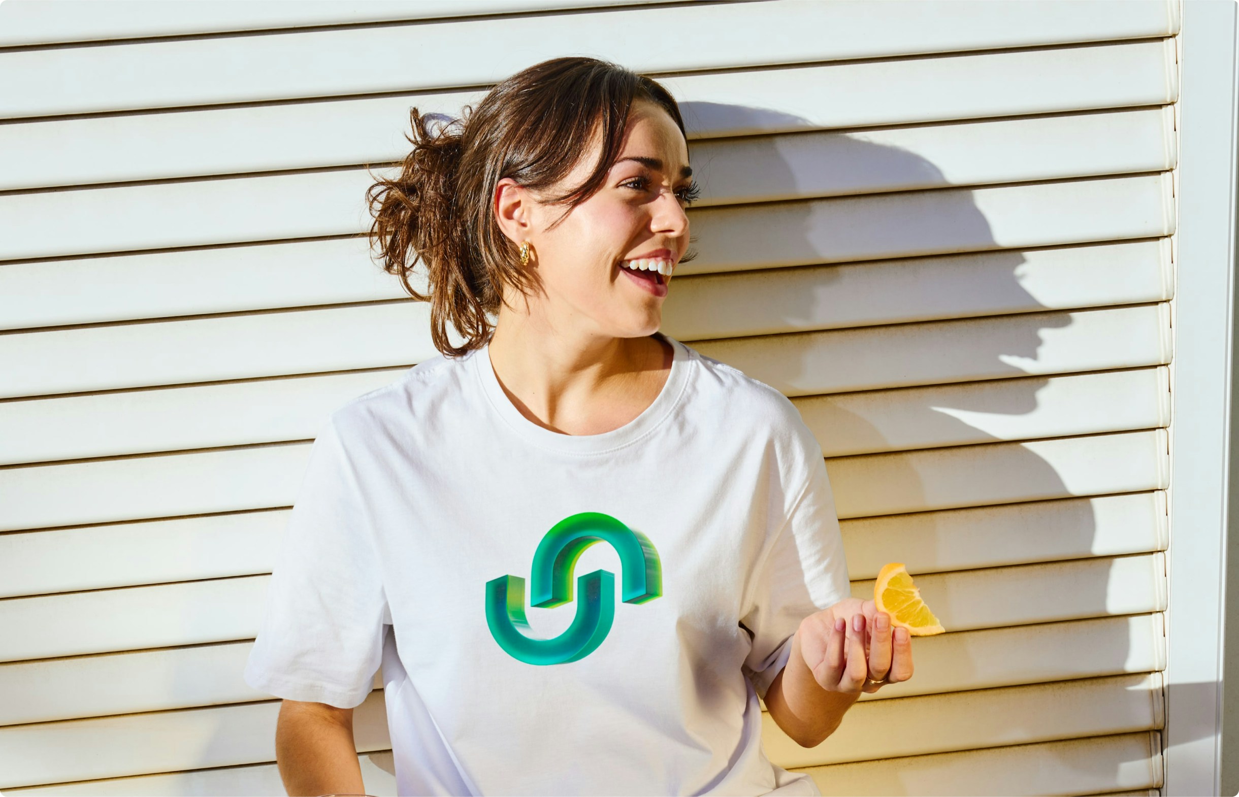 Woman wearing Upshop-branded apparel in a bright, casual setting, reflecting the brand’s approachable personality.