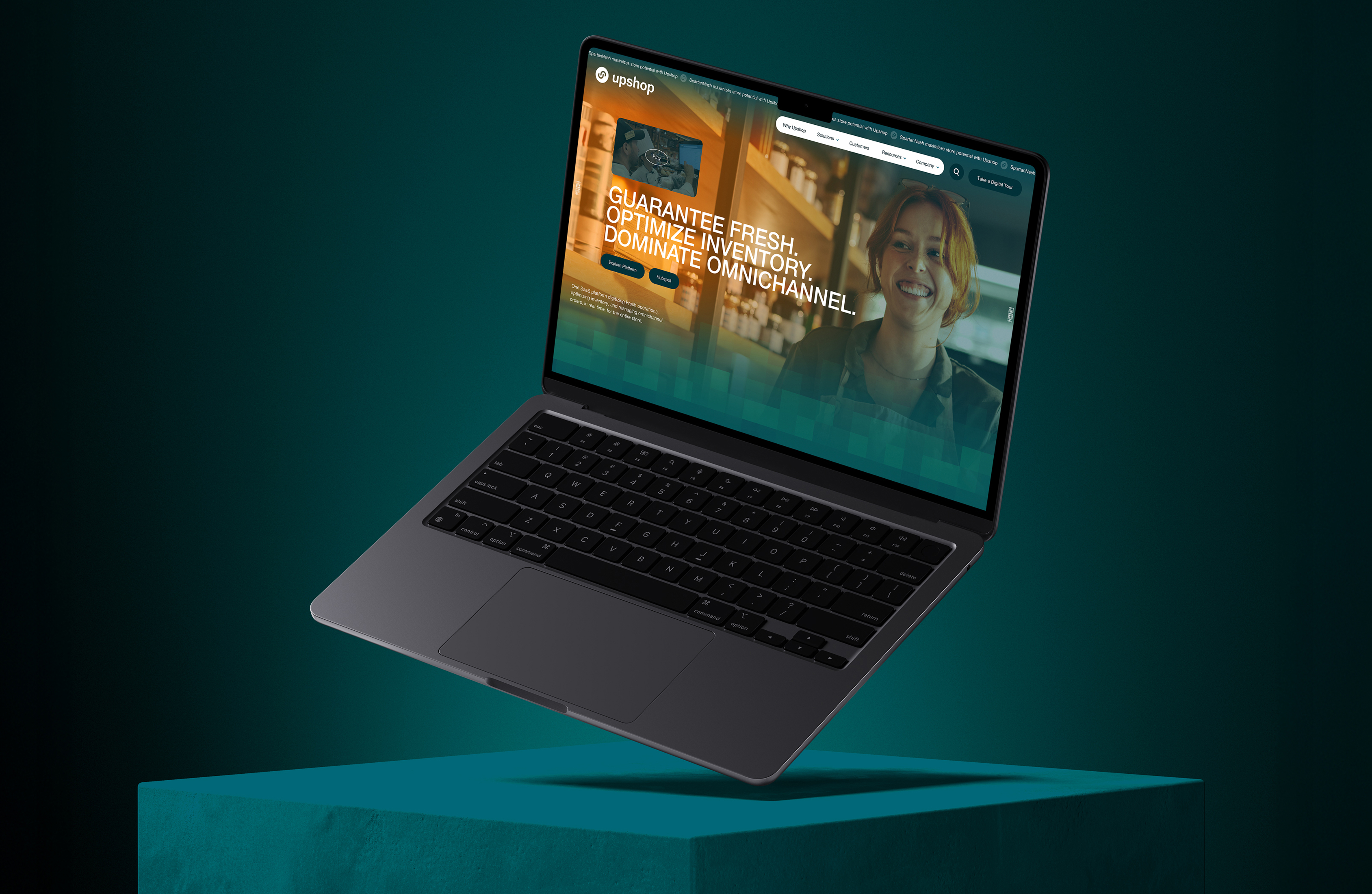 Laptop displaying Upshop platform UI in a dim ambient setting.