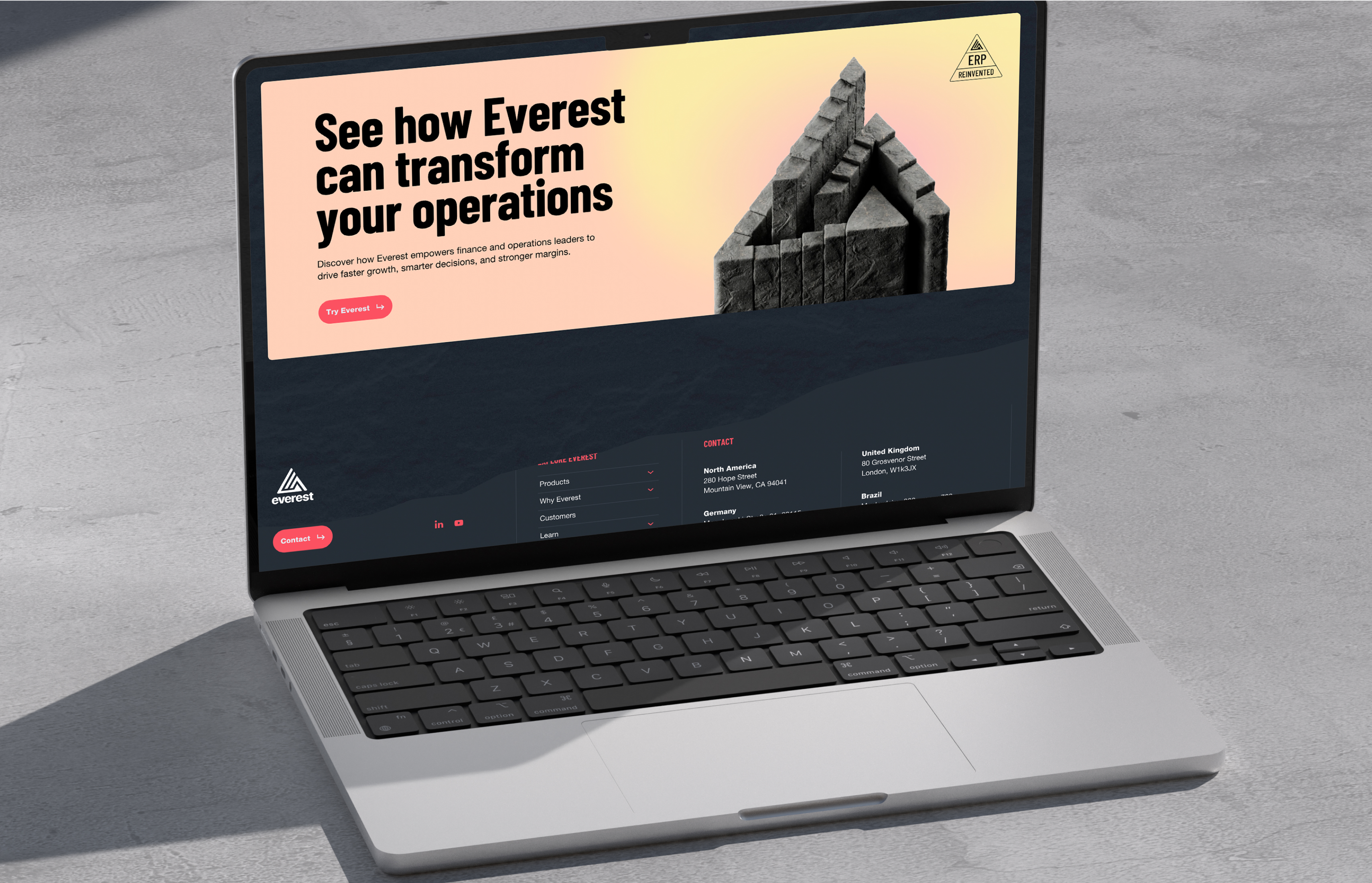 Laptop mockup showing the Everest ERP homepage with bold headline and visual hierarchy.