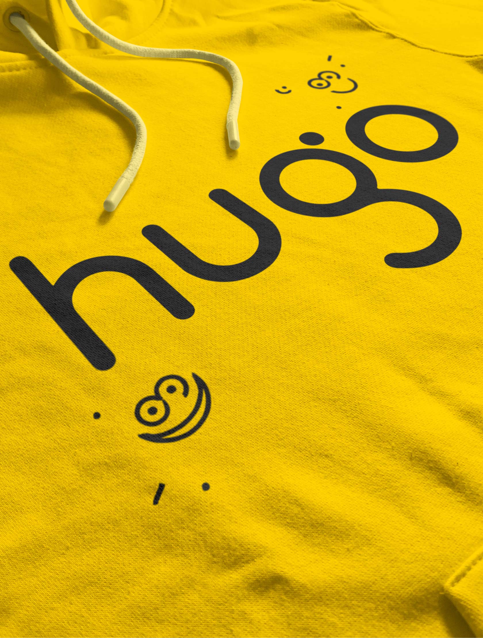Yellow hoodie displaying the Hugo brand smiley-style logo.