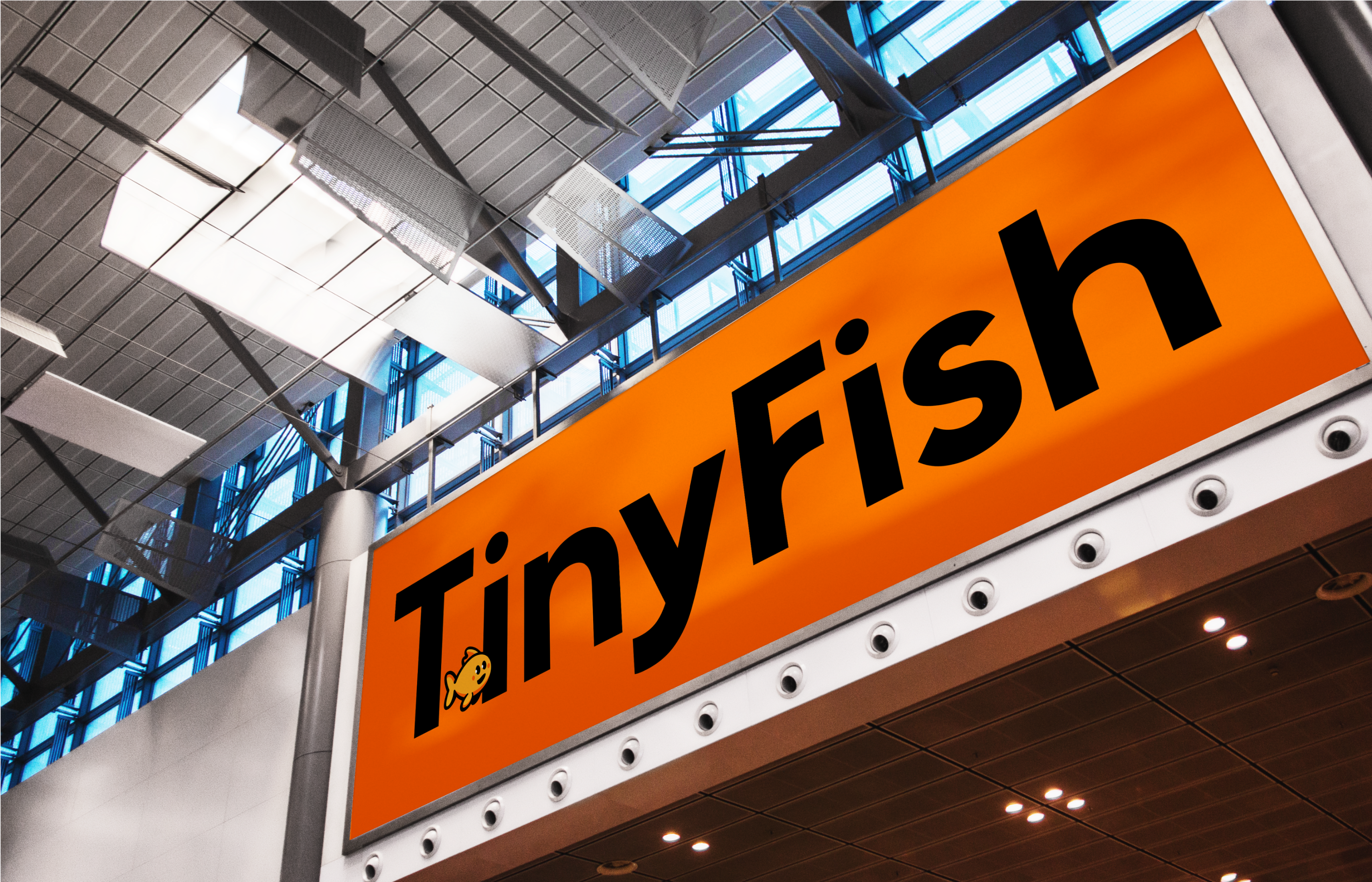 Overhead signage at an indoor event featuring the TinyFish logo and color palette.