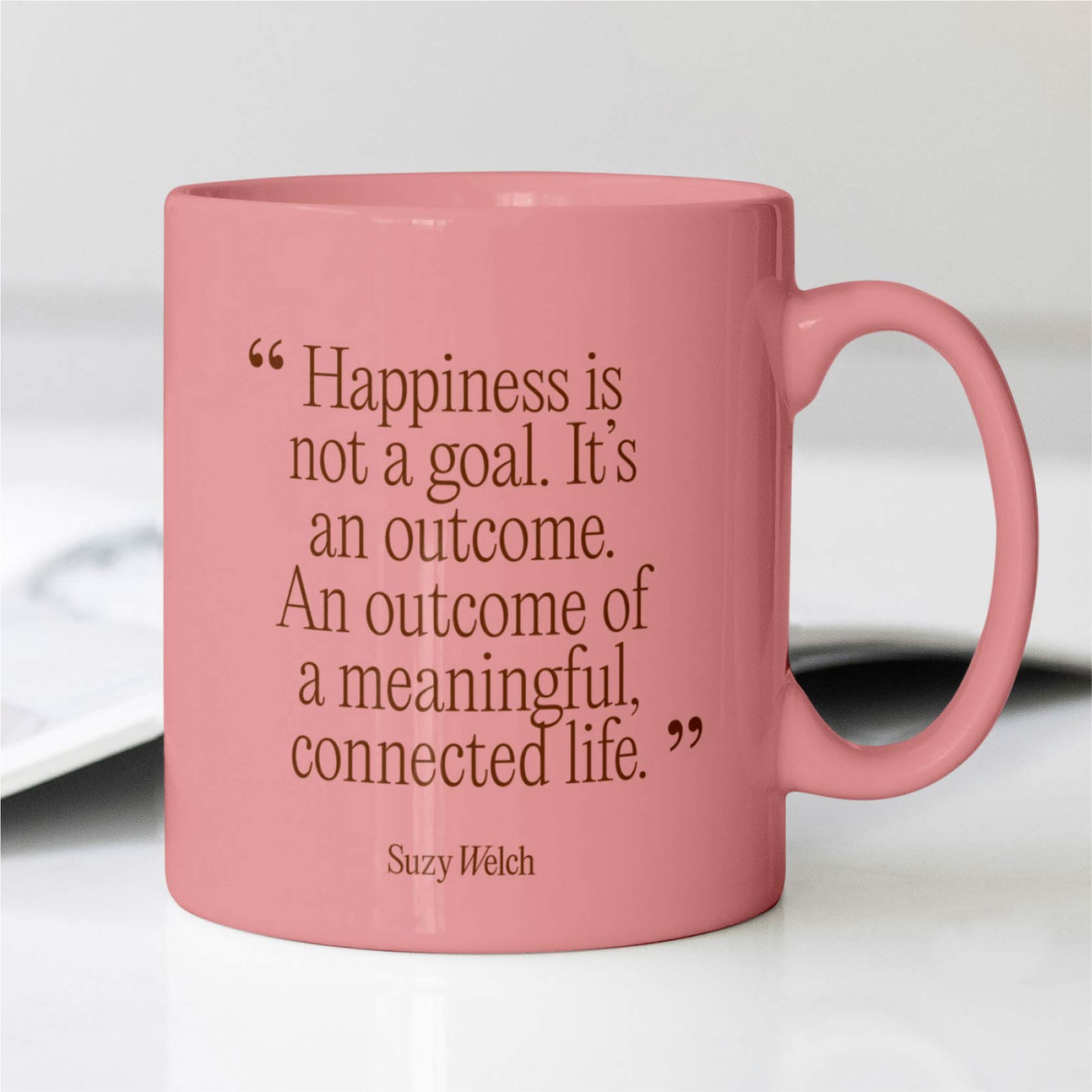 Pink ceramic mug printed with a Suzy Welch inspirational quote.
