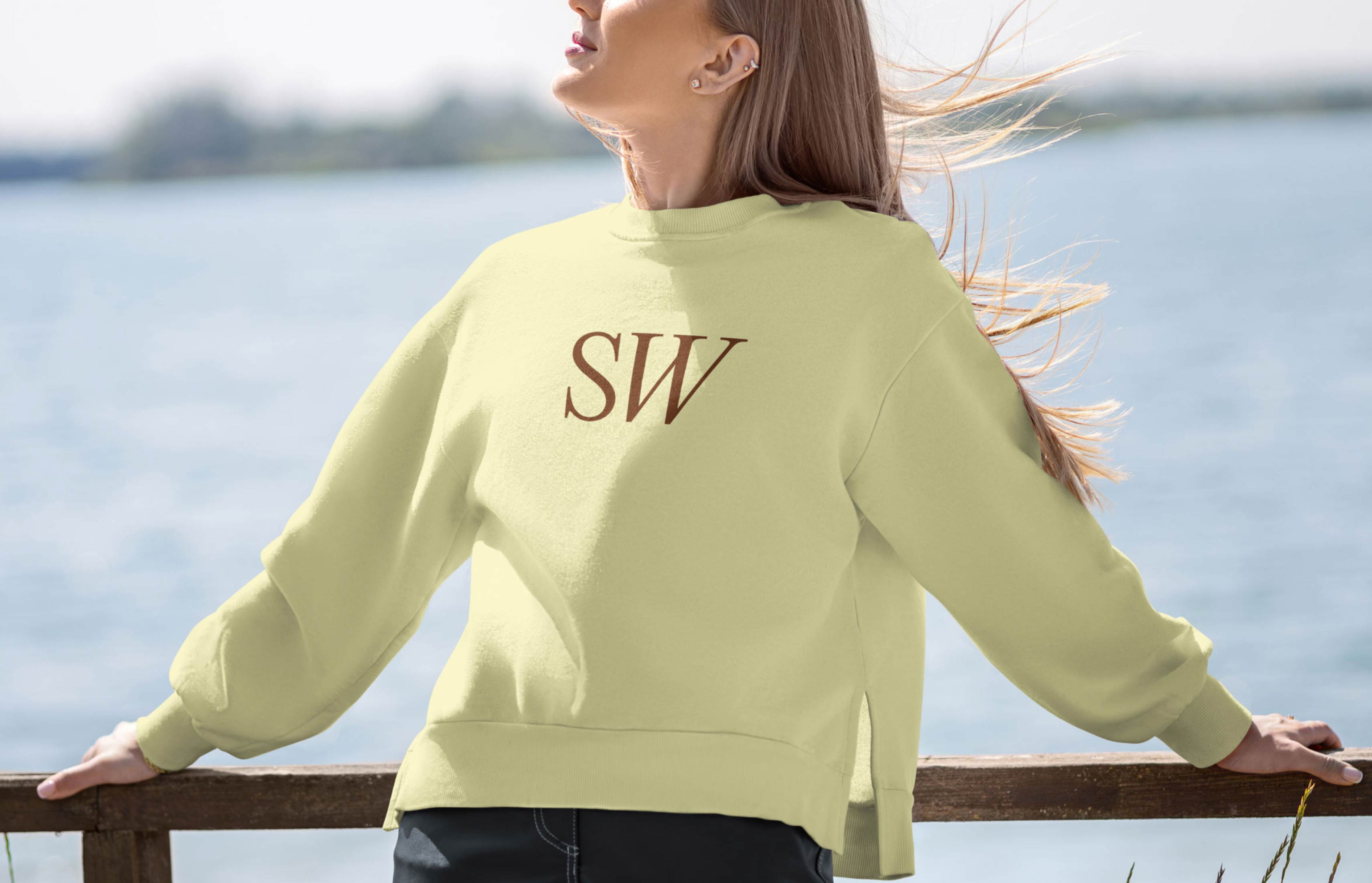 Woman wearing a Suzy Welch branded sweatshirt photographed outdoors.