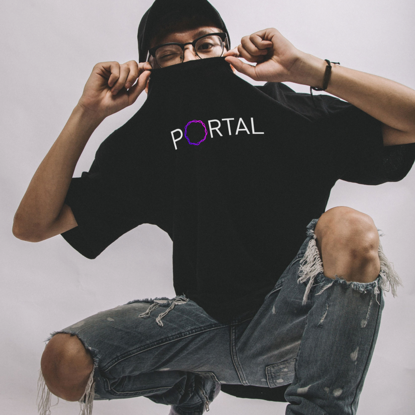 Photograph of a person wearing Portal-branded apparel in a studio pose.