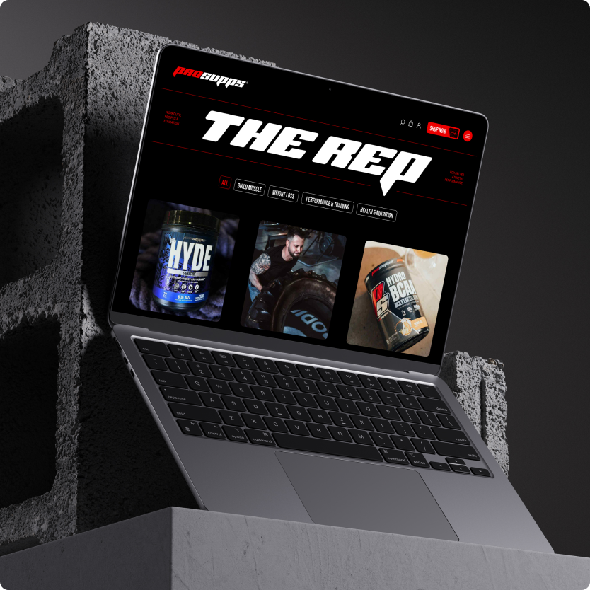 Laptop displaying ProSupps’ homepage featuring product visuals and athlete photography.